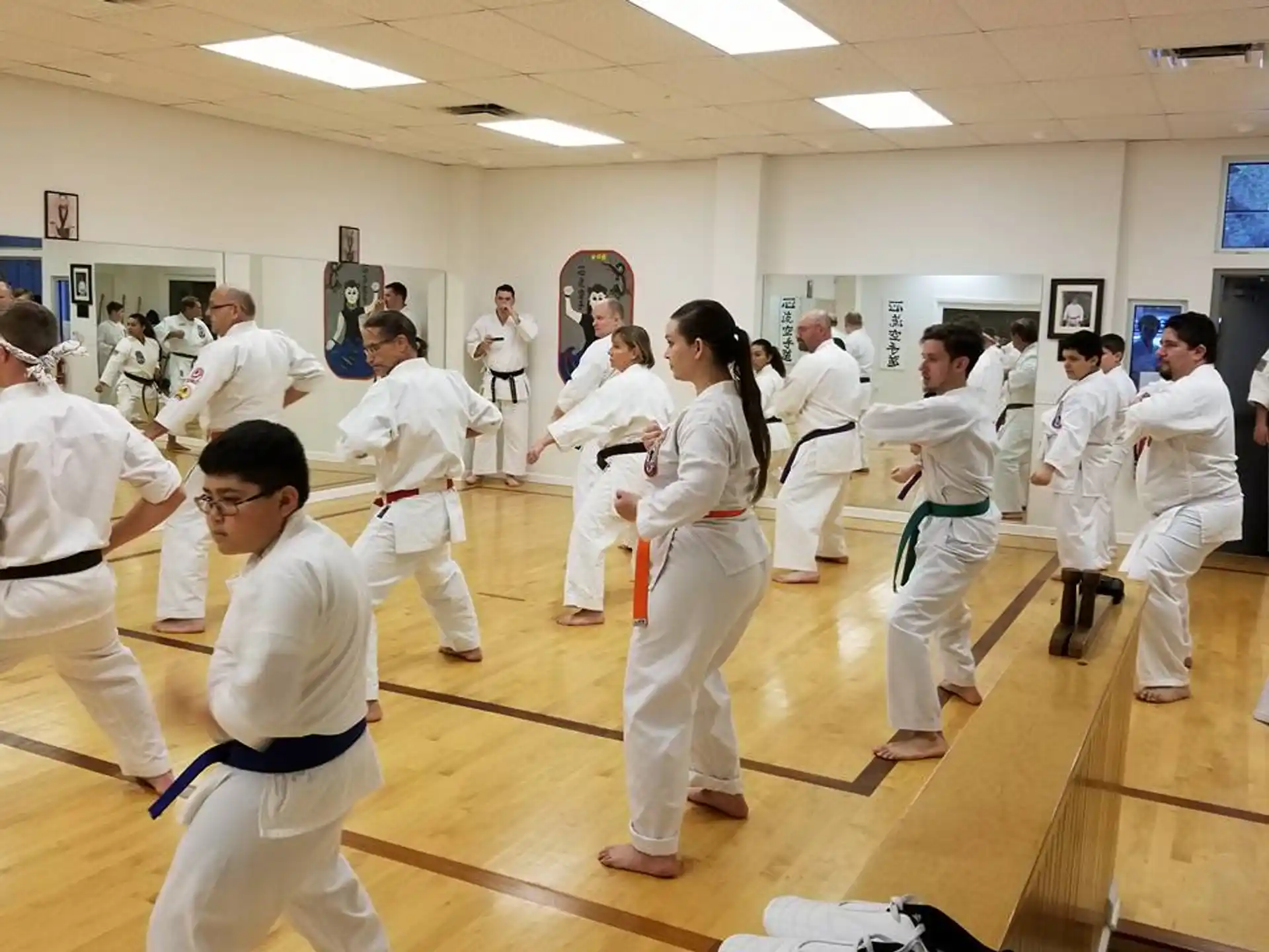 a group of people in white karate uniforms