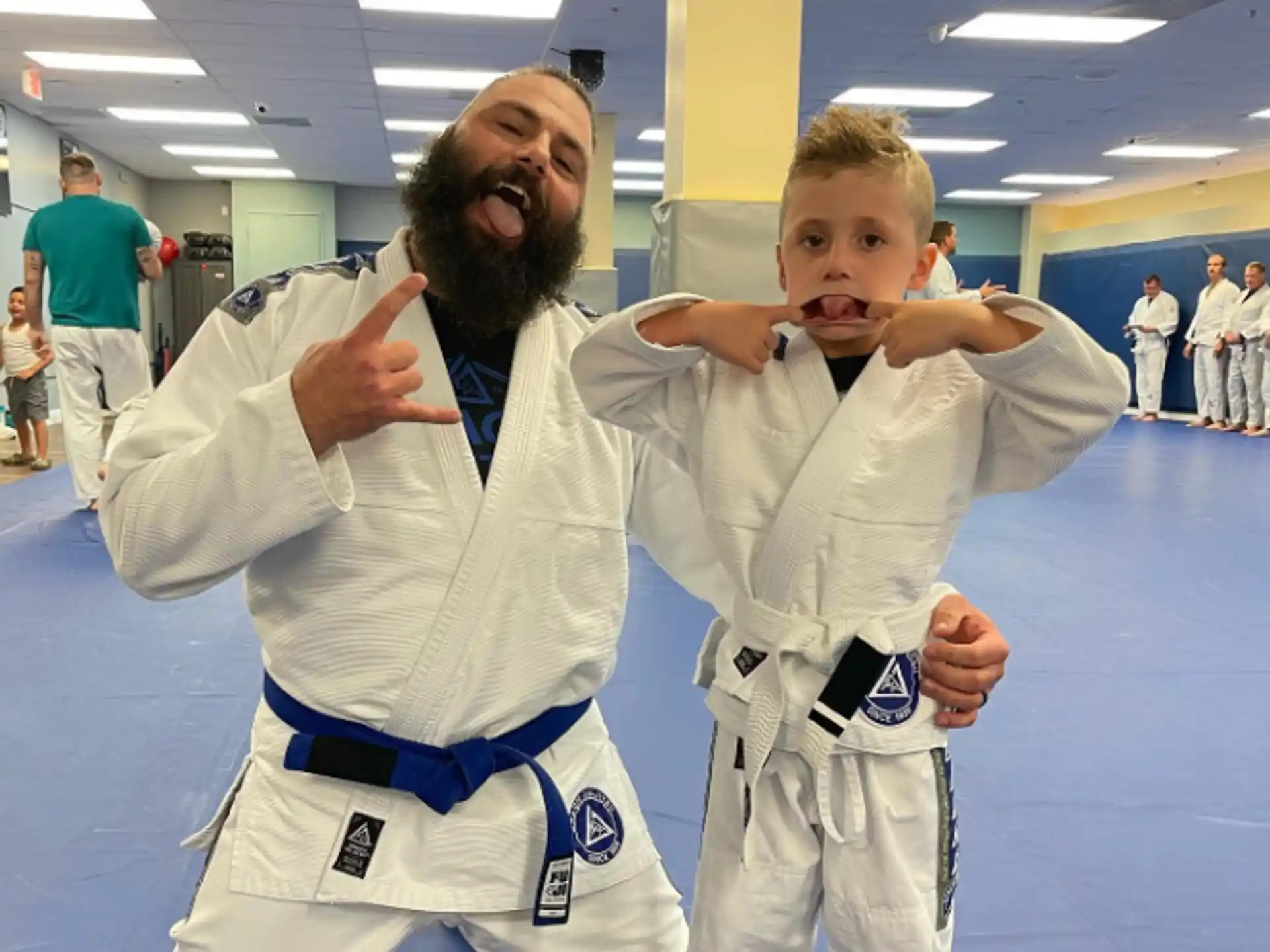 a person and a boy in karate uniforms