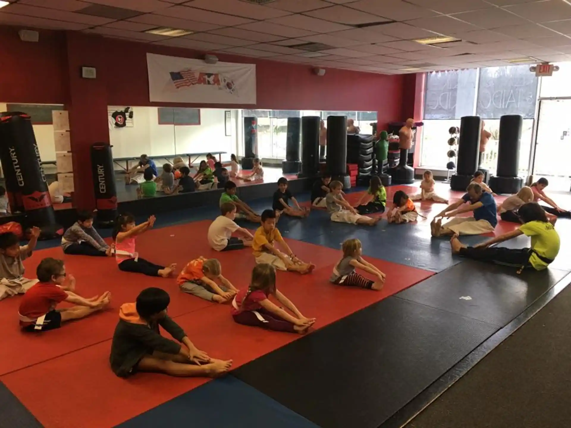 a group of children sitting on the floor in a room