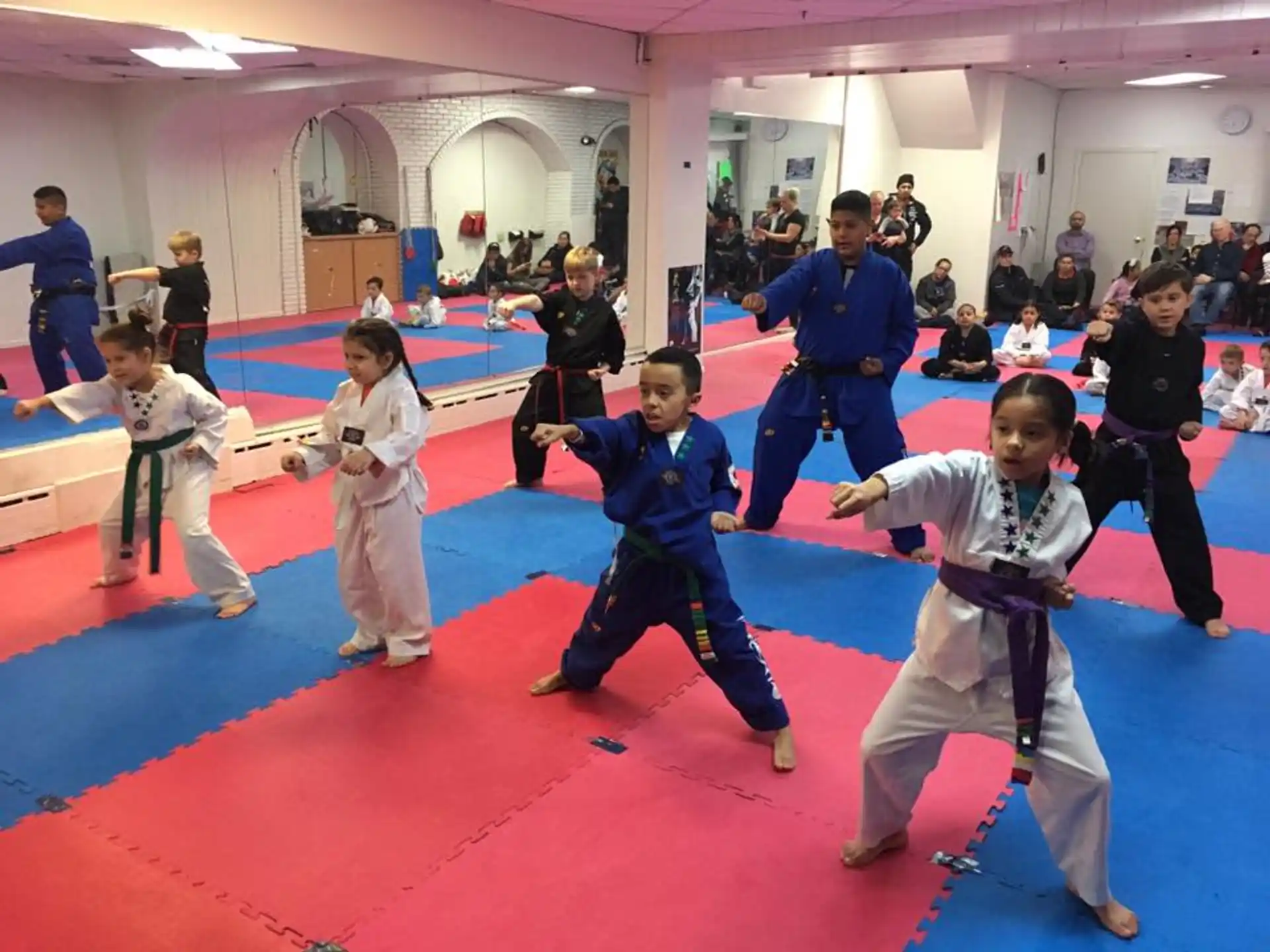 a group of children in karate uniforms