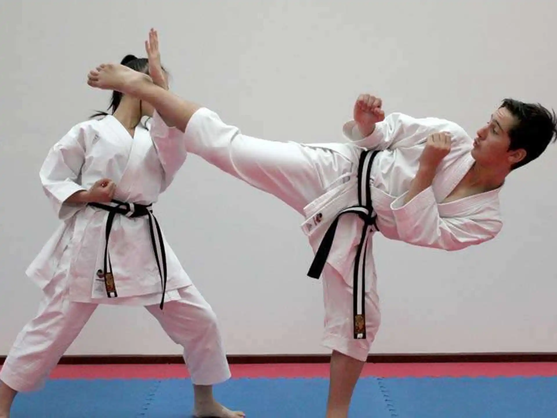a group of people in karate uniforms