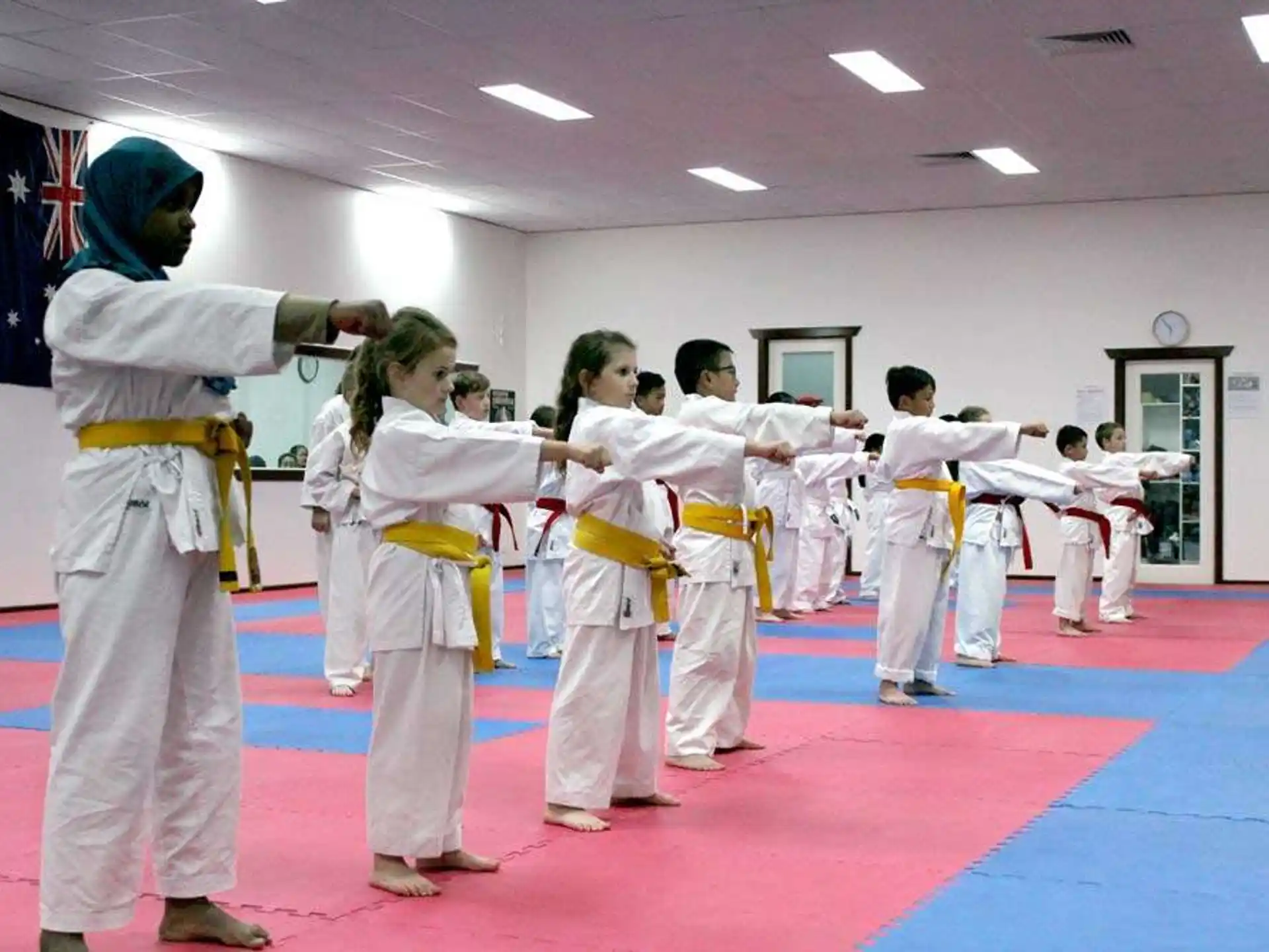 a group of people in white karate uniforms