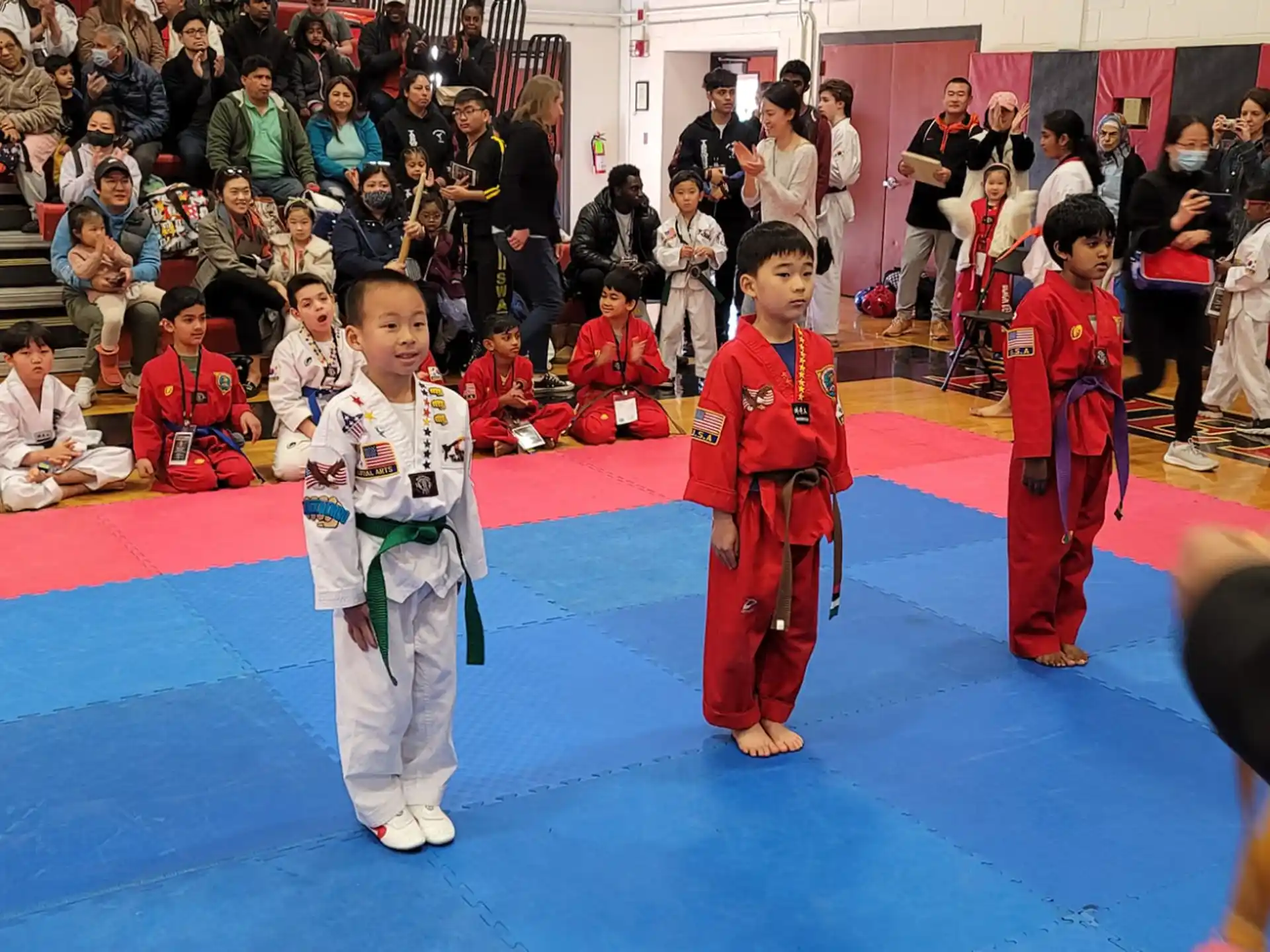 a group of children in karate uniforms