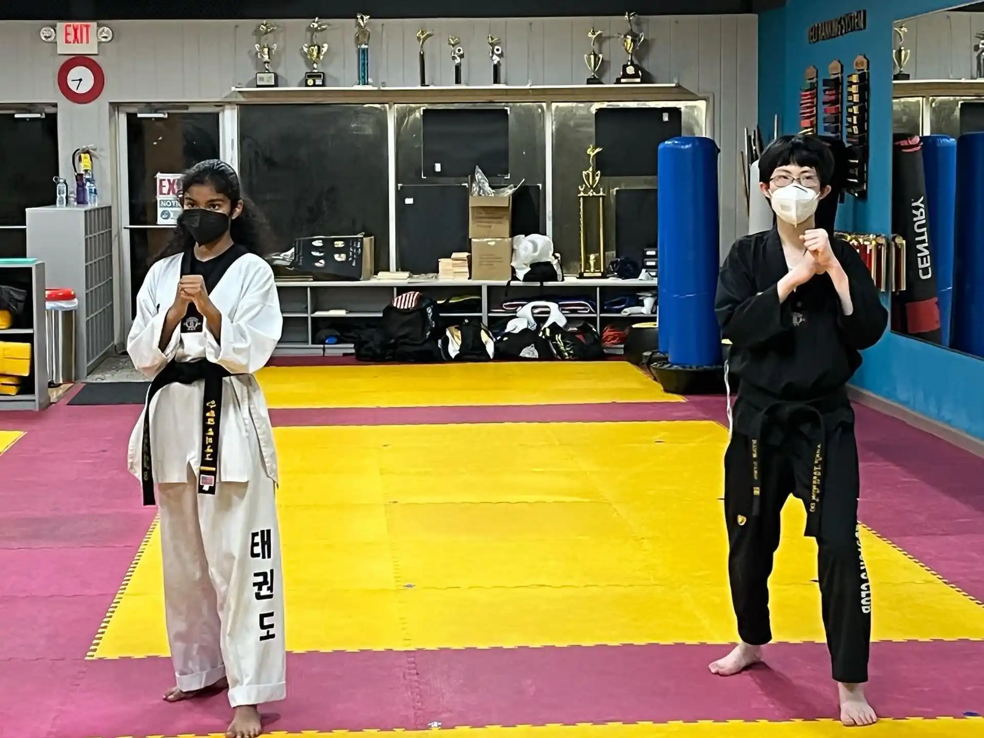 two people wearing masks