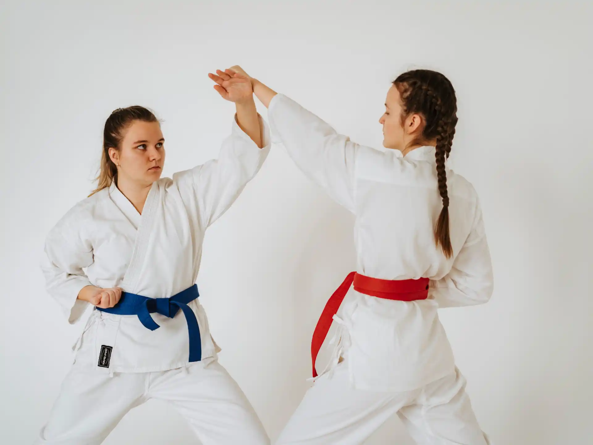 a couple of women in karate uniforms