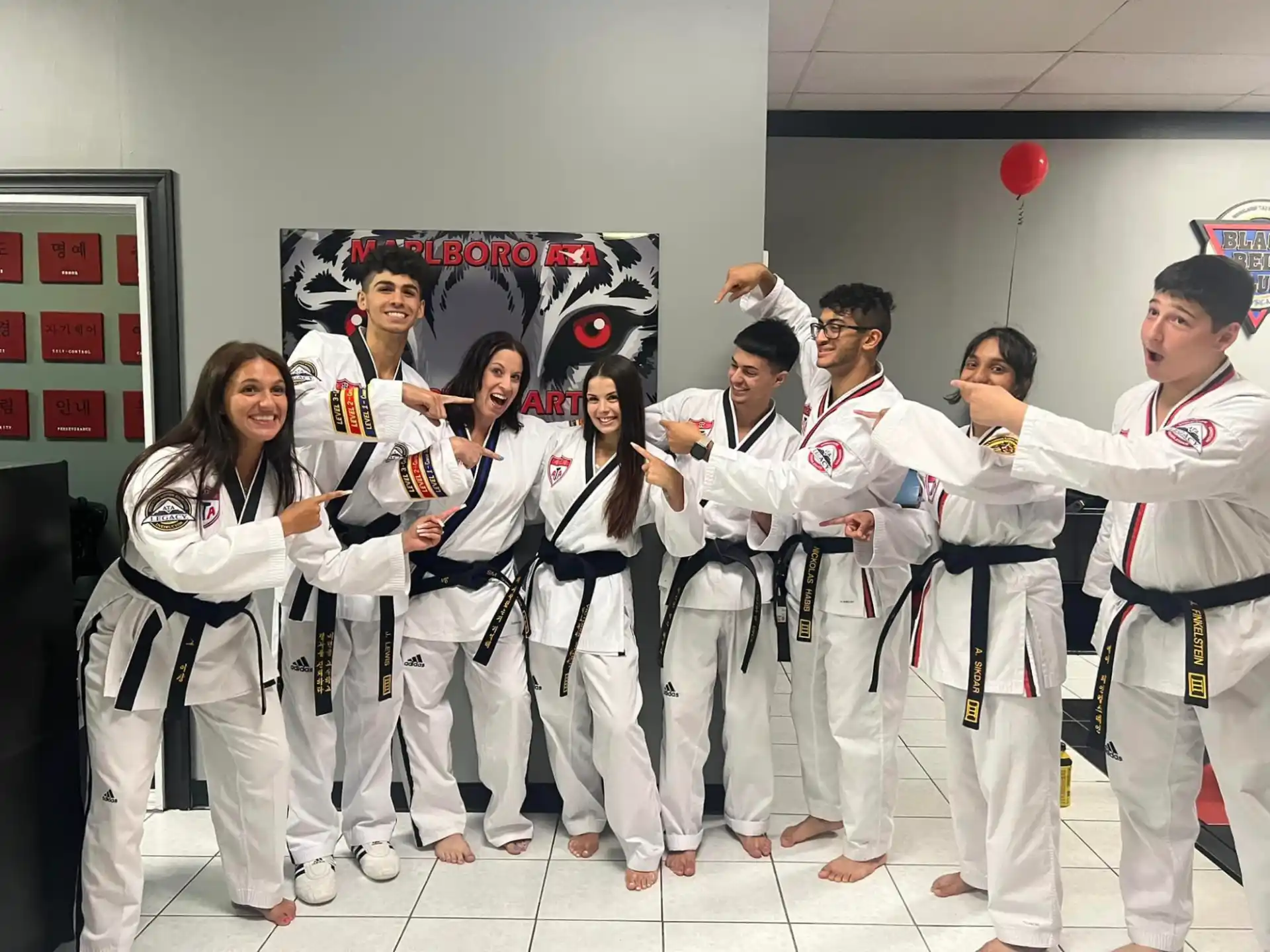 a group of people in white karate uniforms