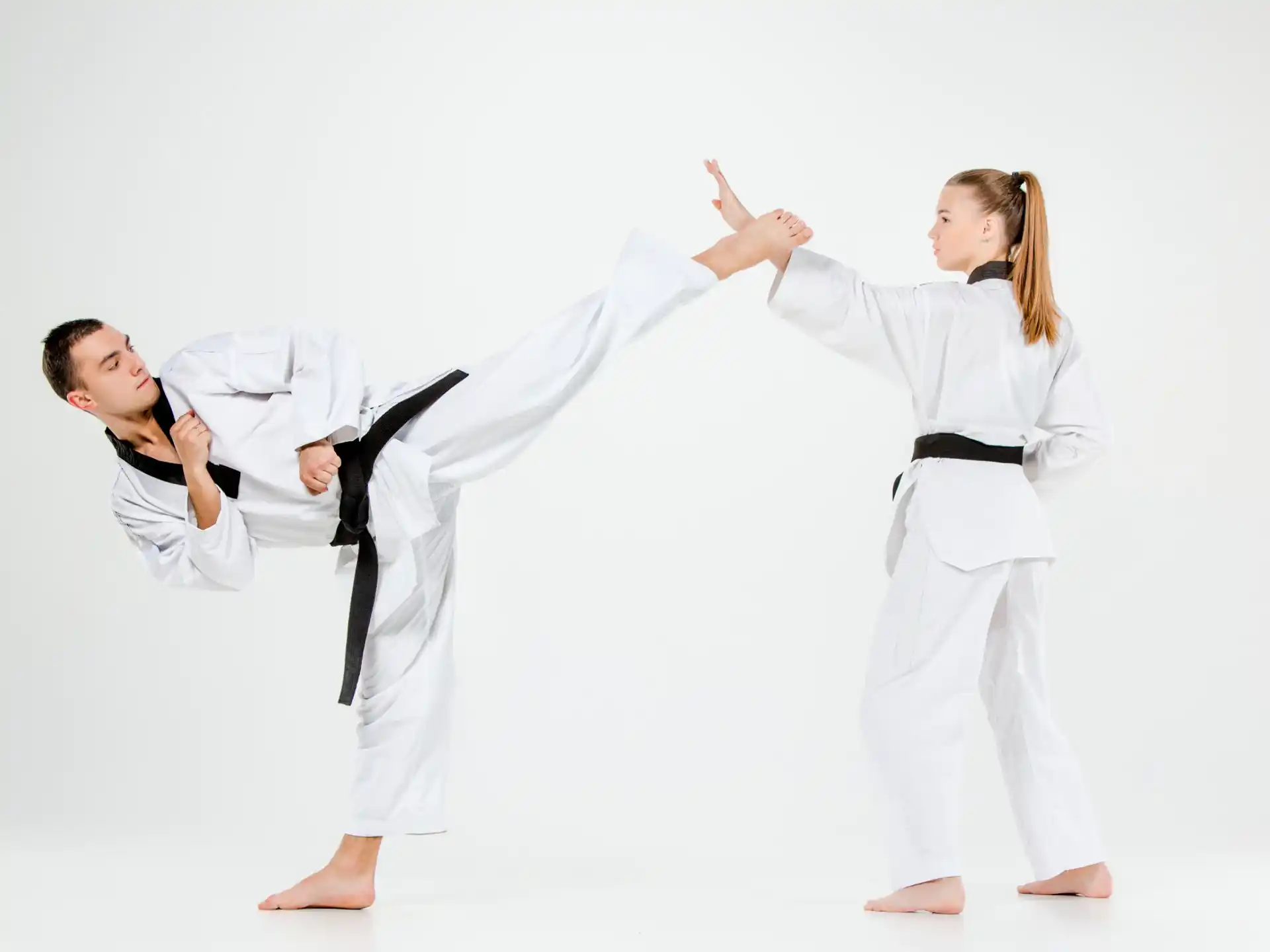 a man and a woman in karate uniforms