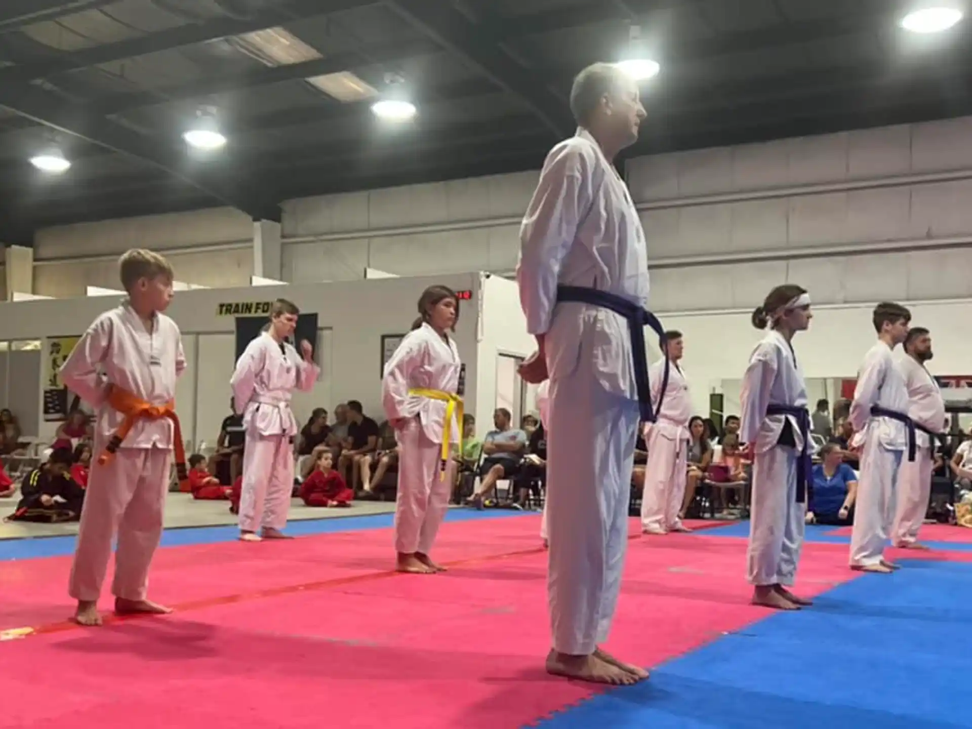 a group of people in karate uniforms