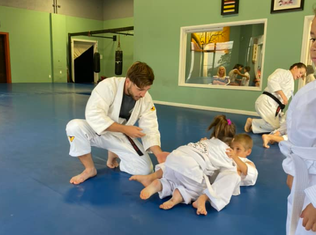 a group of people in karate uniforms