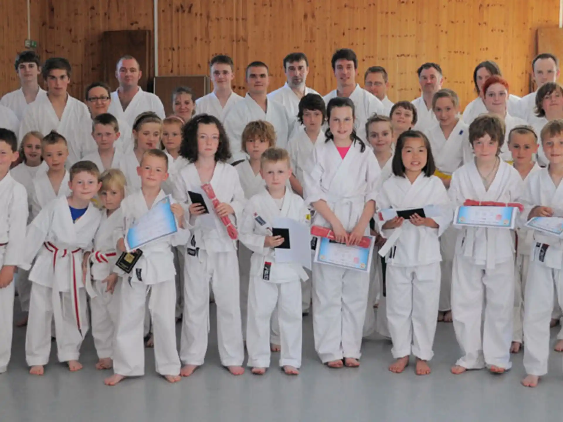 a group of people wearing white karate uniforms