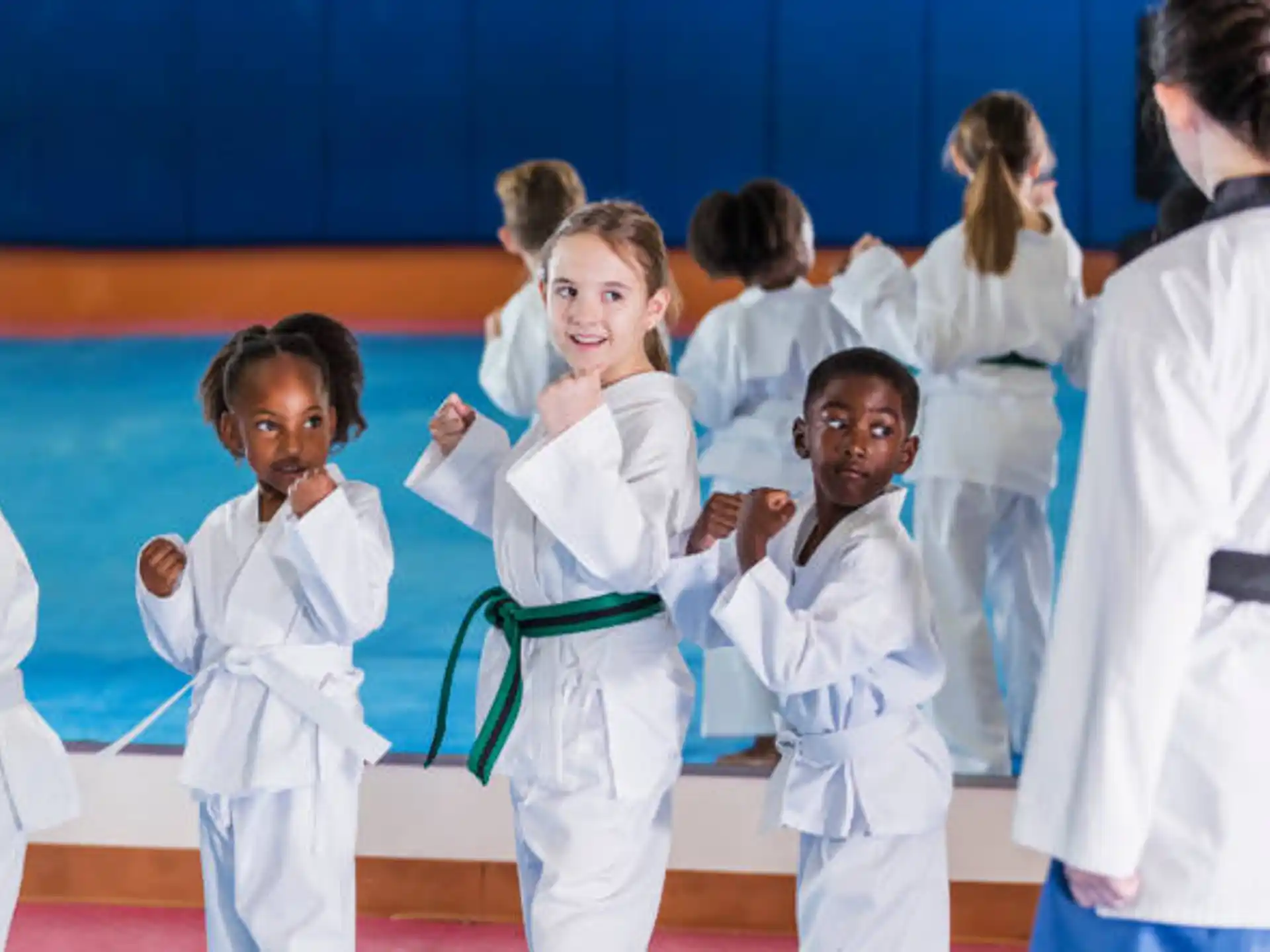 a group of children in white karate uniforms