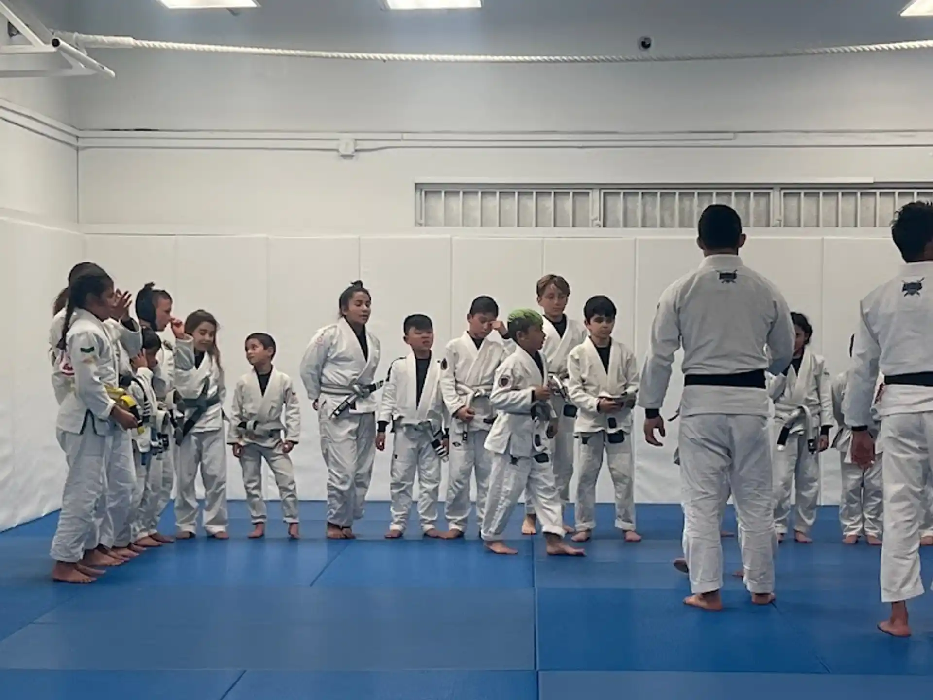 a group of people in white karate uniforms
