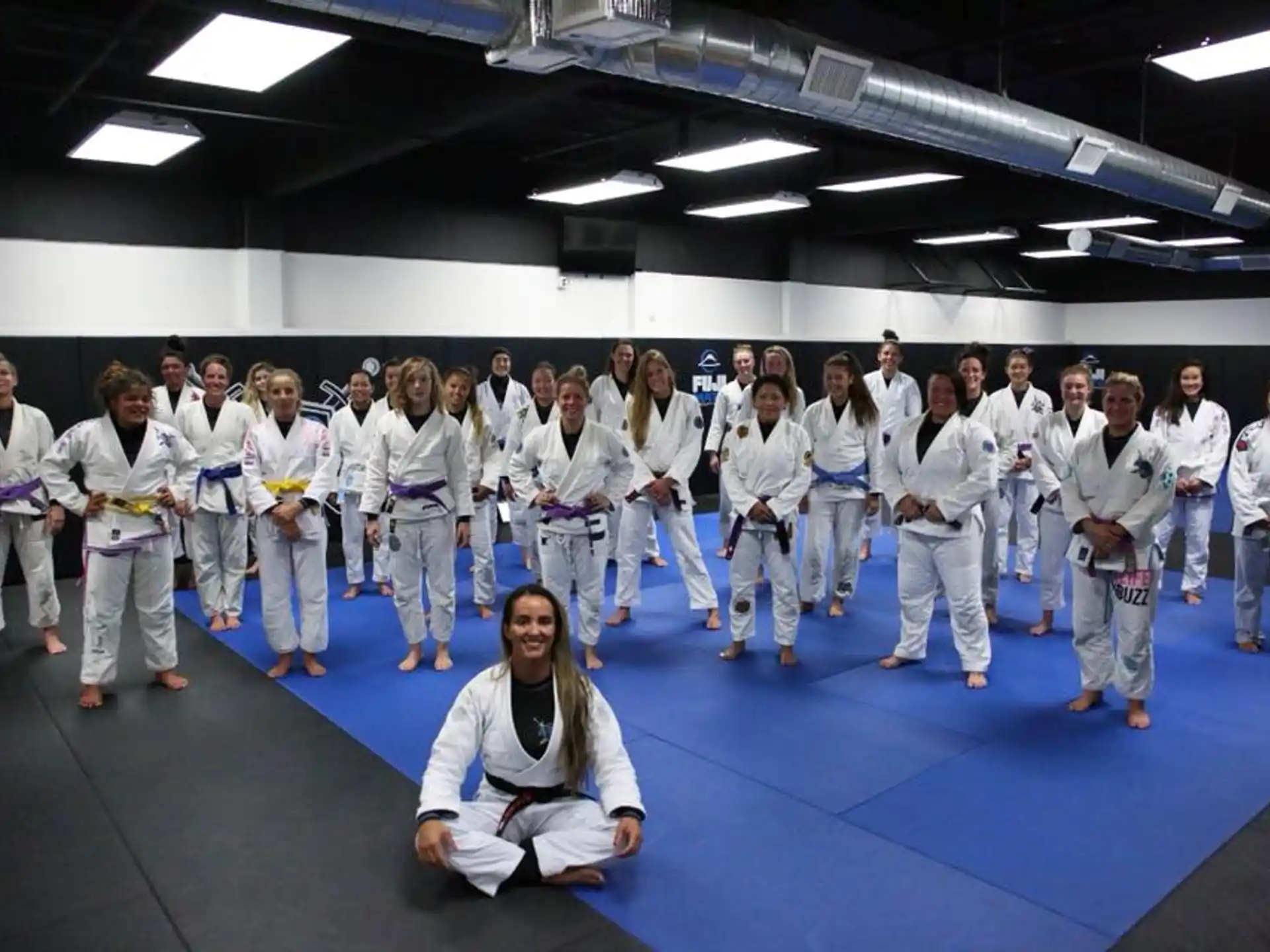a group of people in white karate uniforms