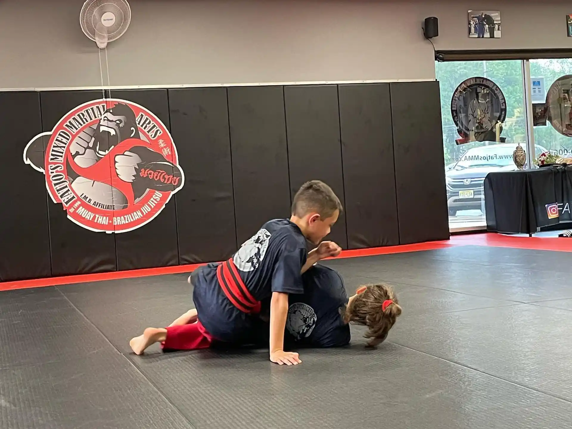 a boy and a girl in a gym