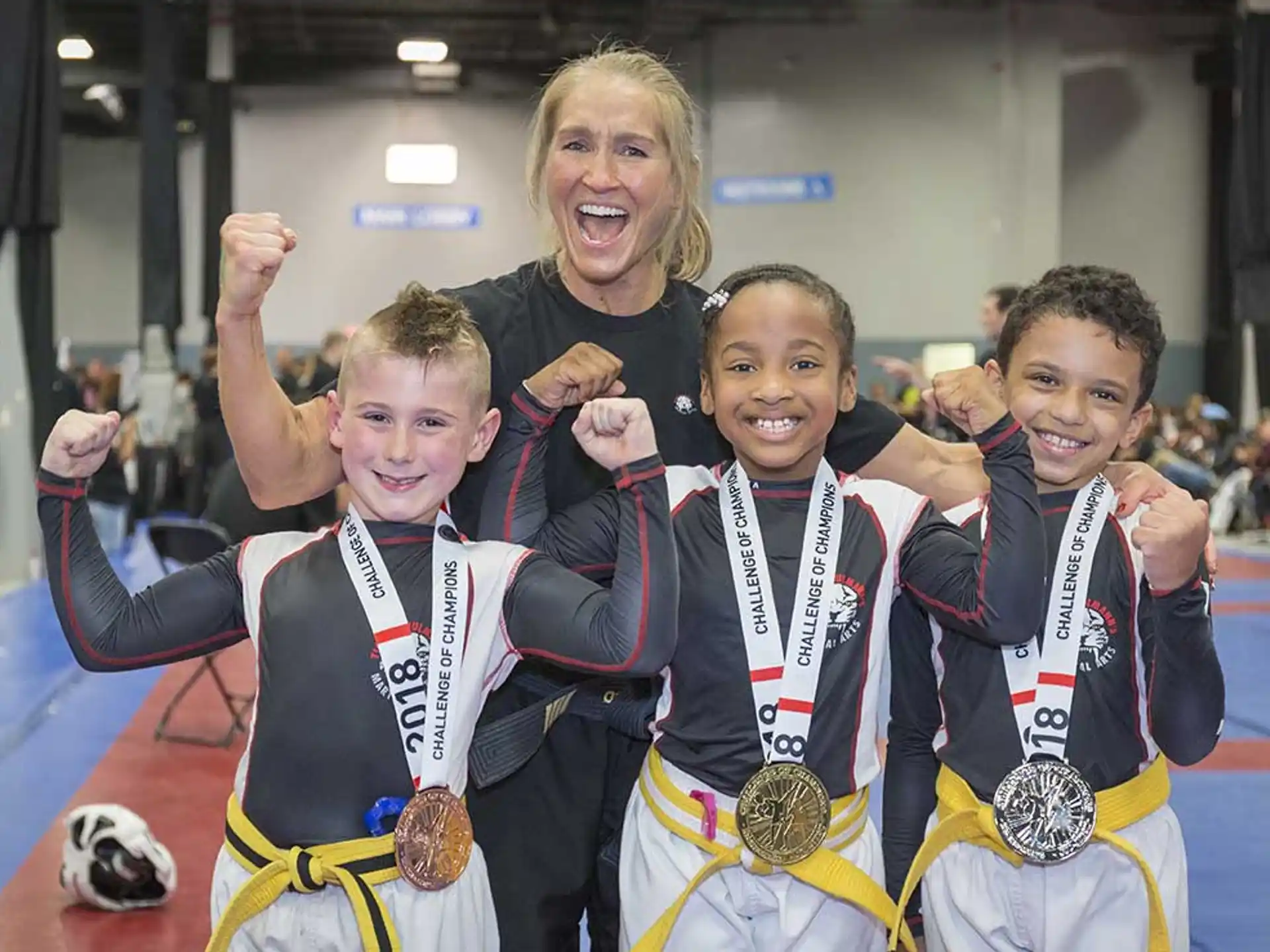 a group of people posing for a photo with medals