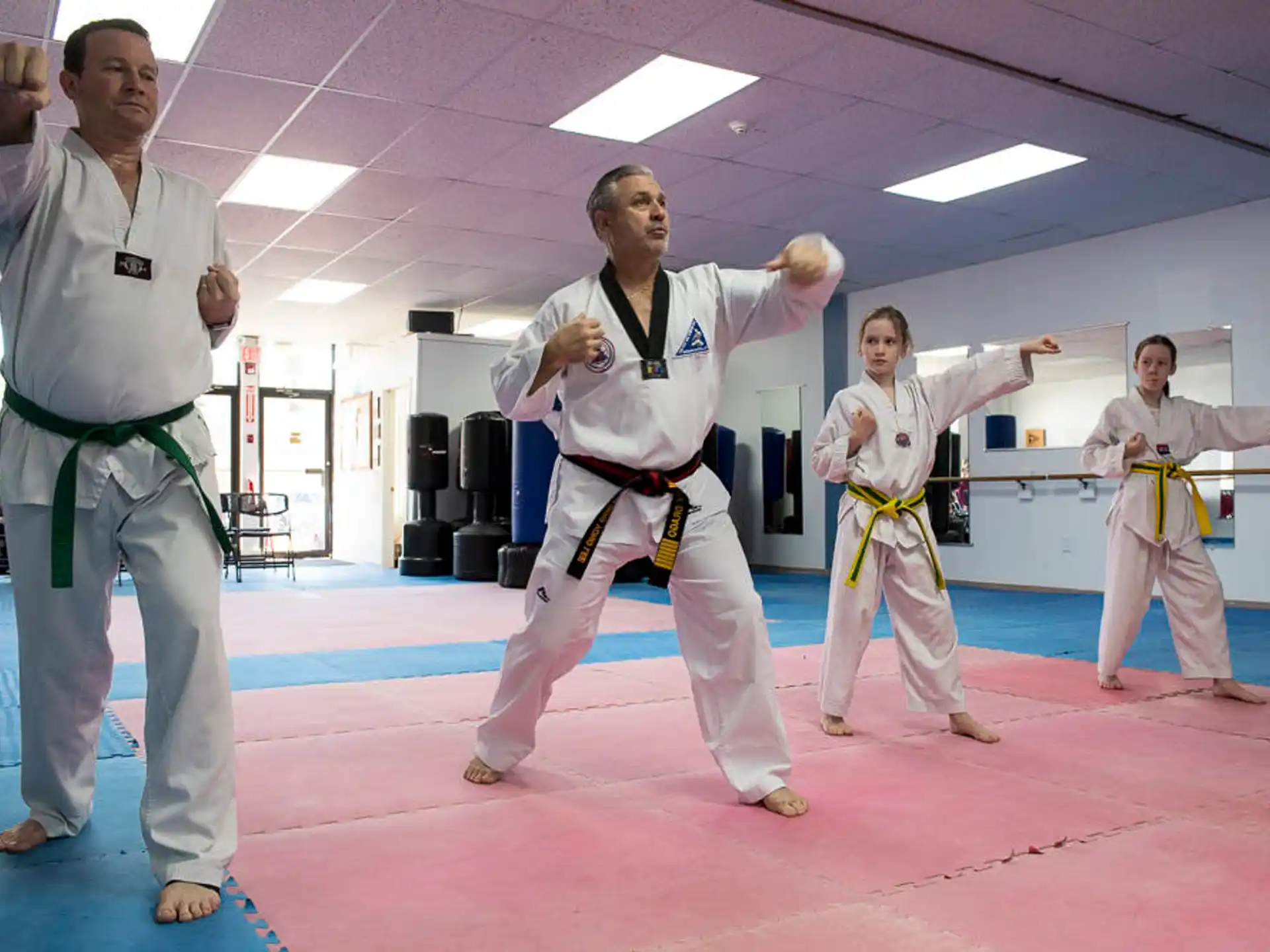 a group of people in karate uniforms