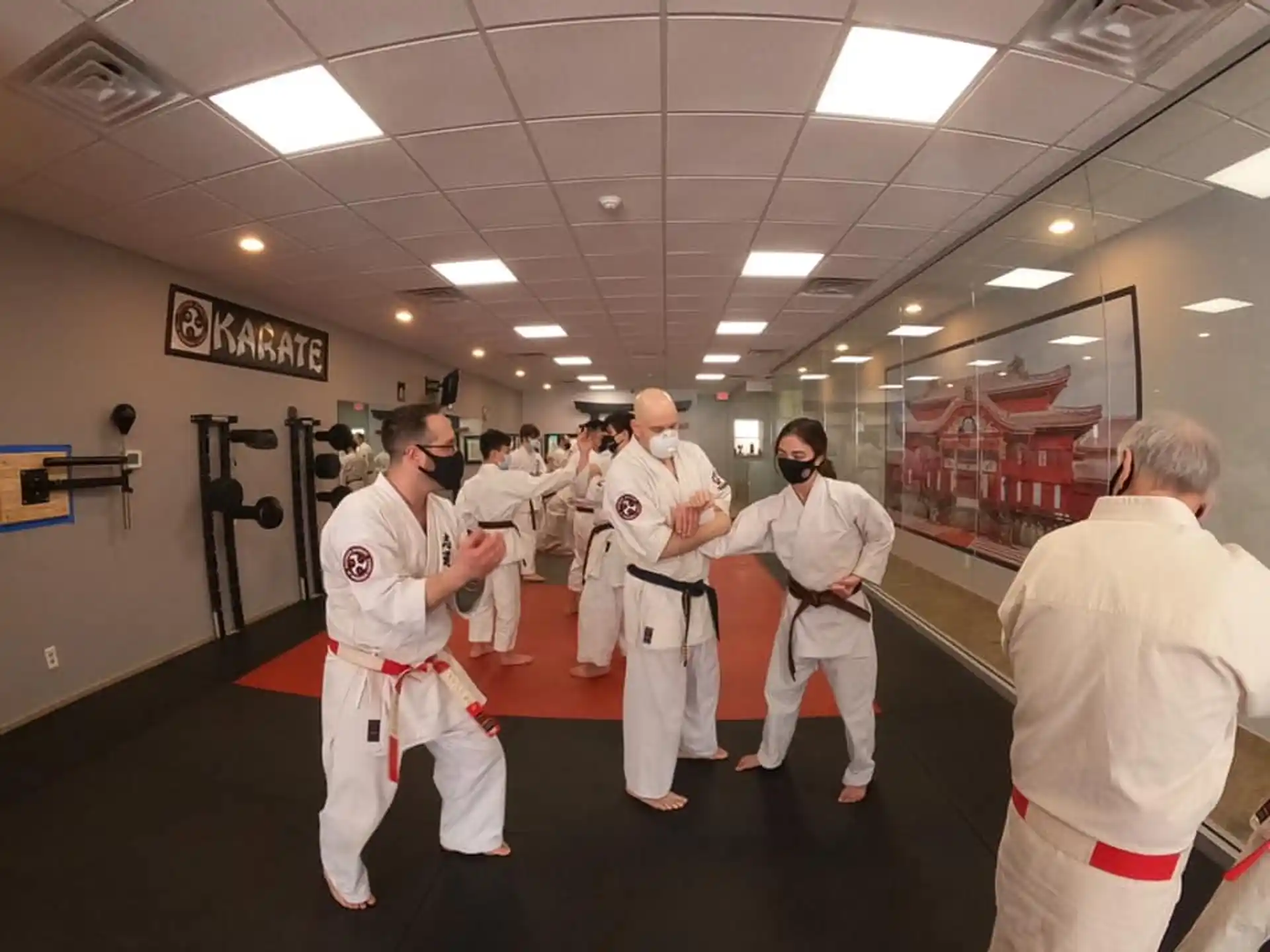 a group of people in white karate uniforms