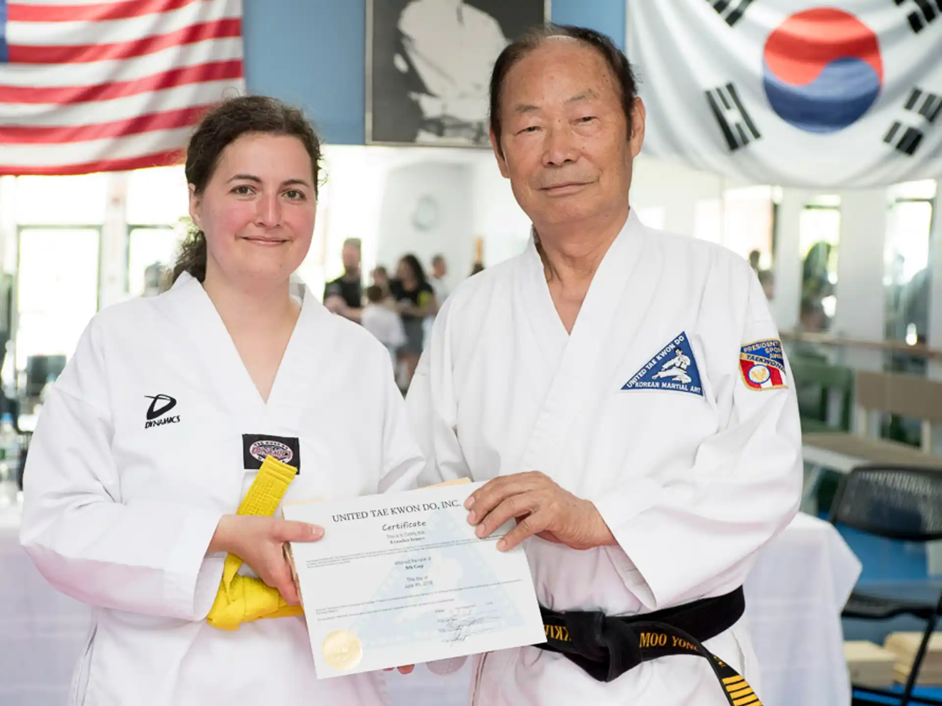 a man and a woman in white uniforms holding a certificate