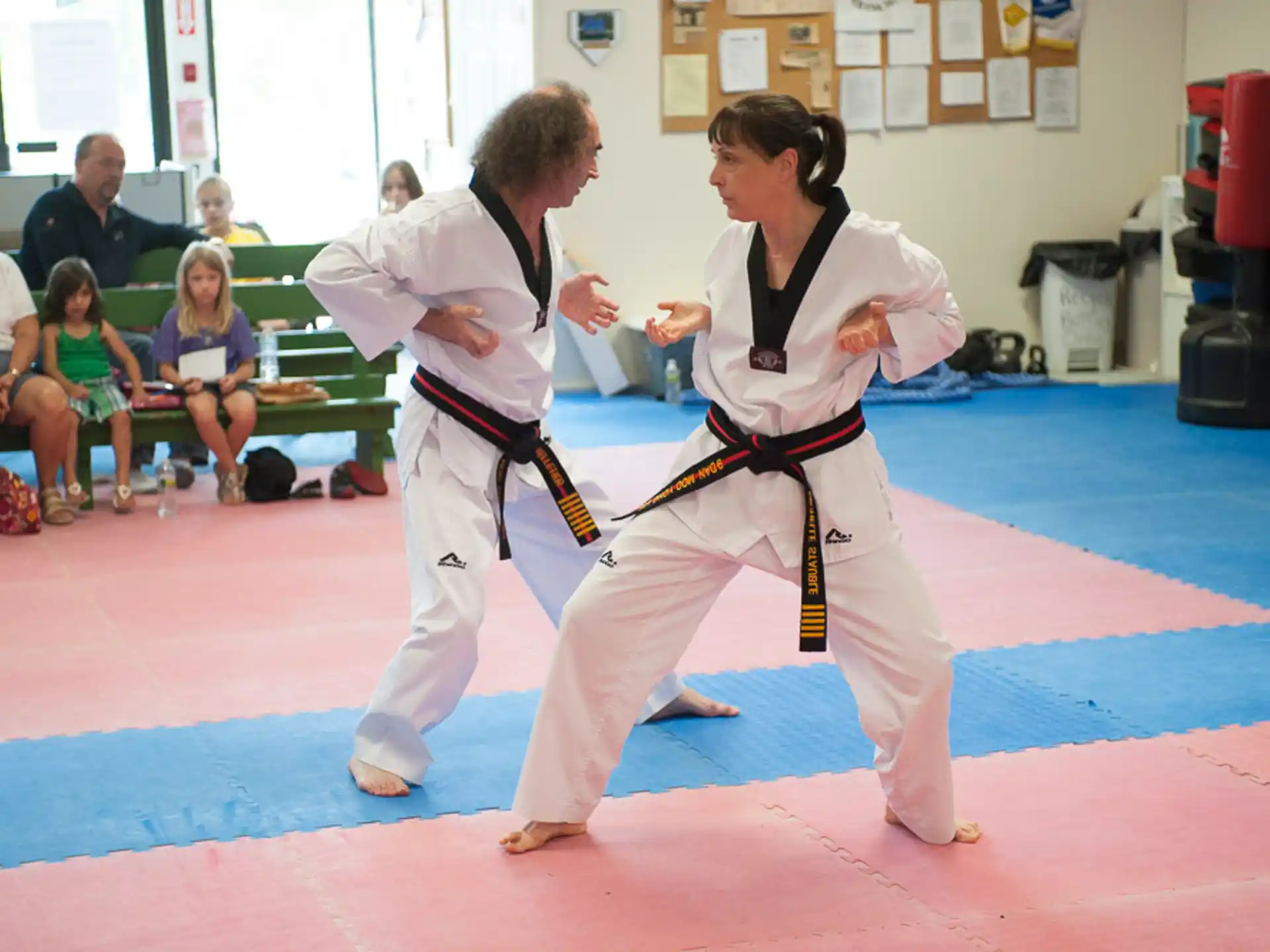 a man and woman in karate uniforms