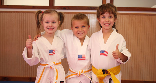 a group of children in white shirts