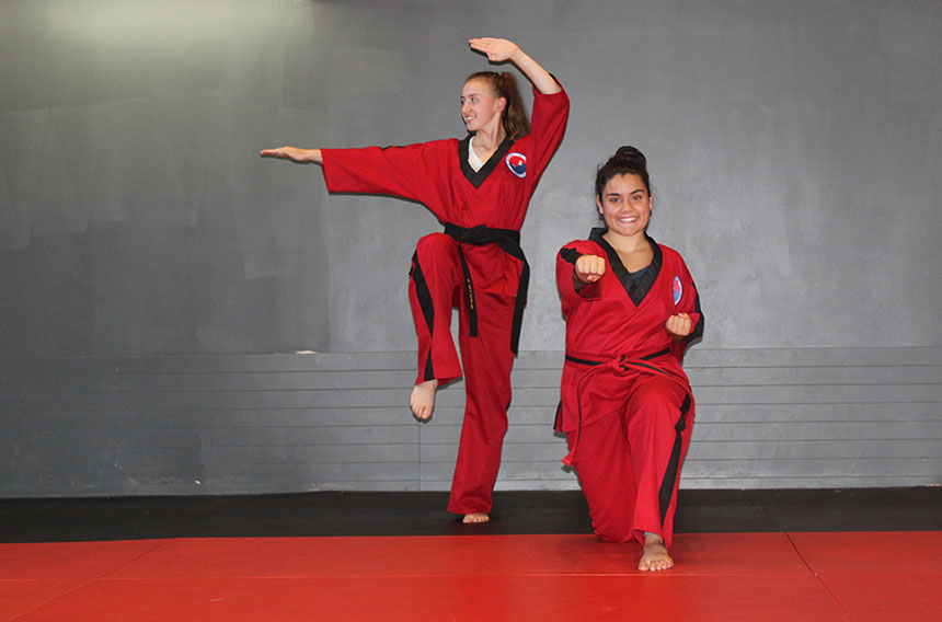 two women in red martial arts uniforms