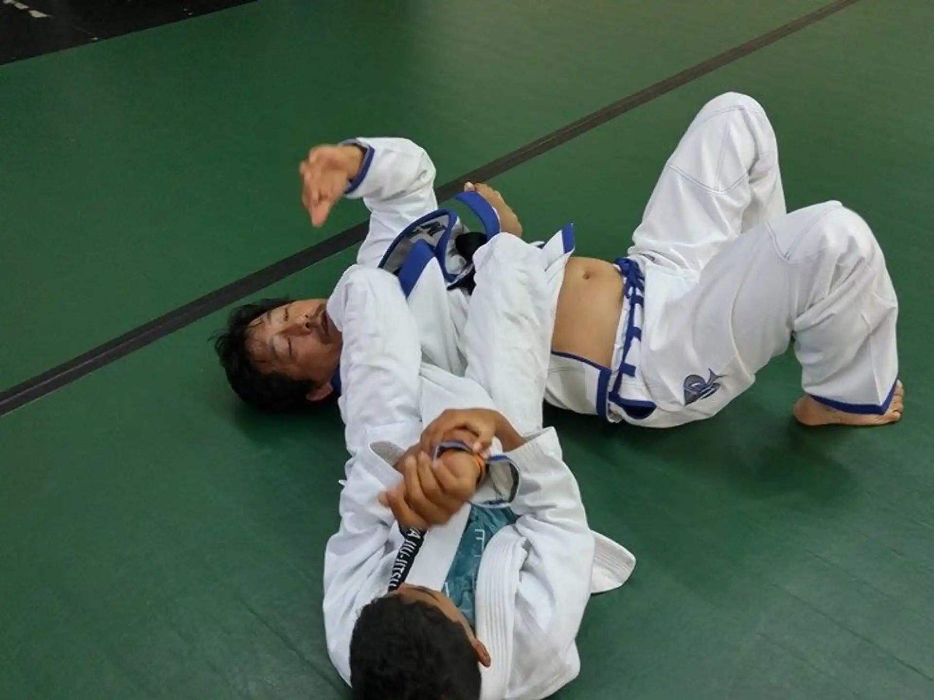 a couple of men in karate uniforms