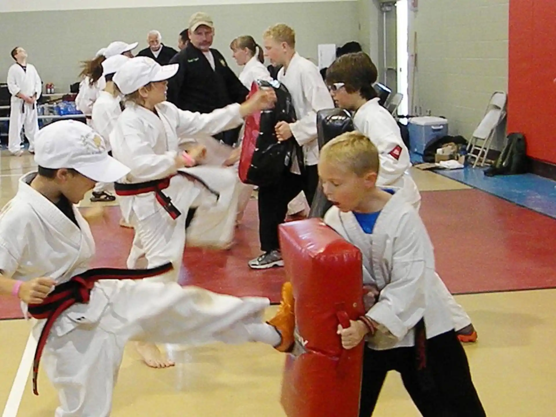 a group of people in white karate uniforms