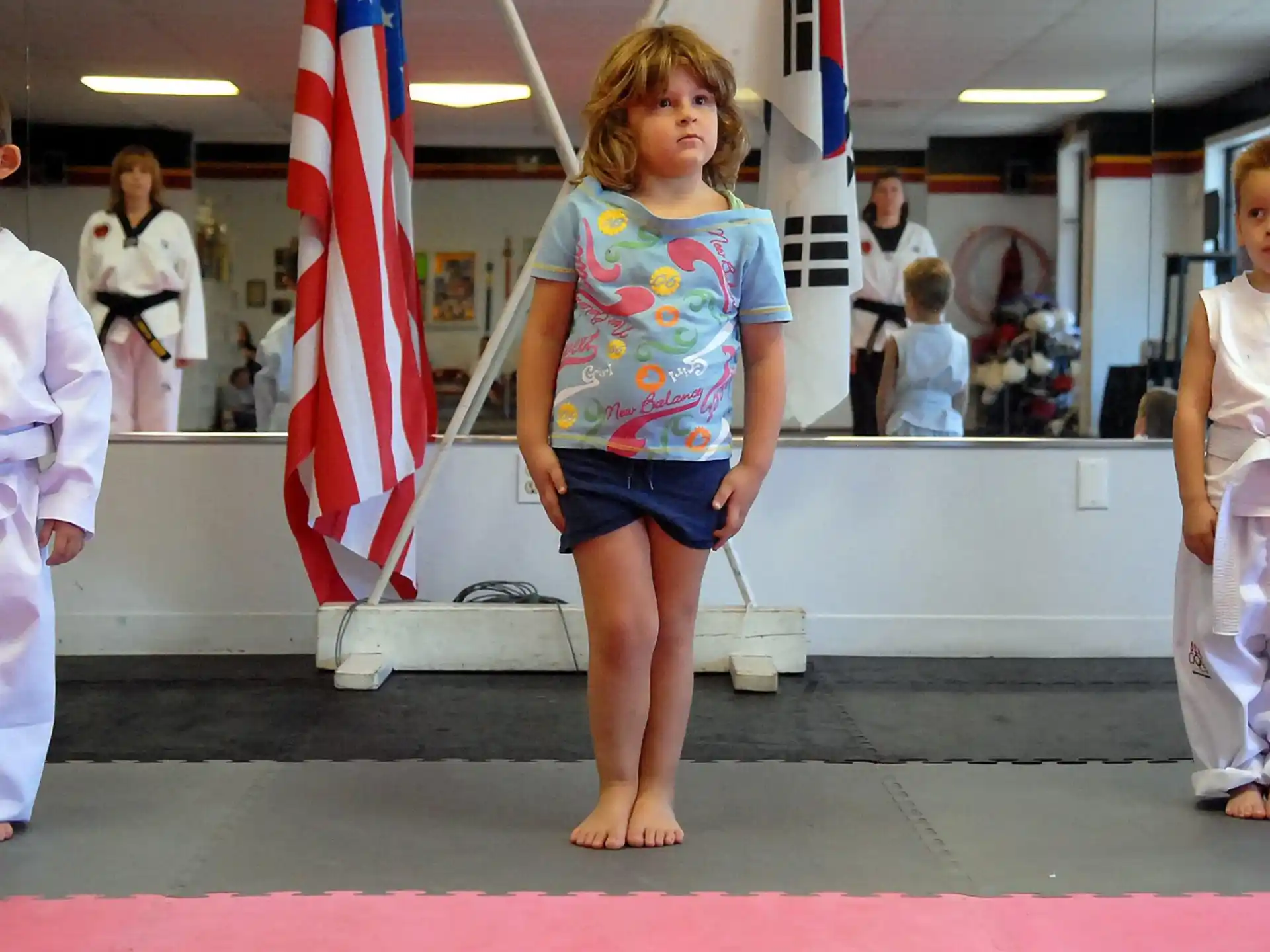 a group of children in karate uniforms