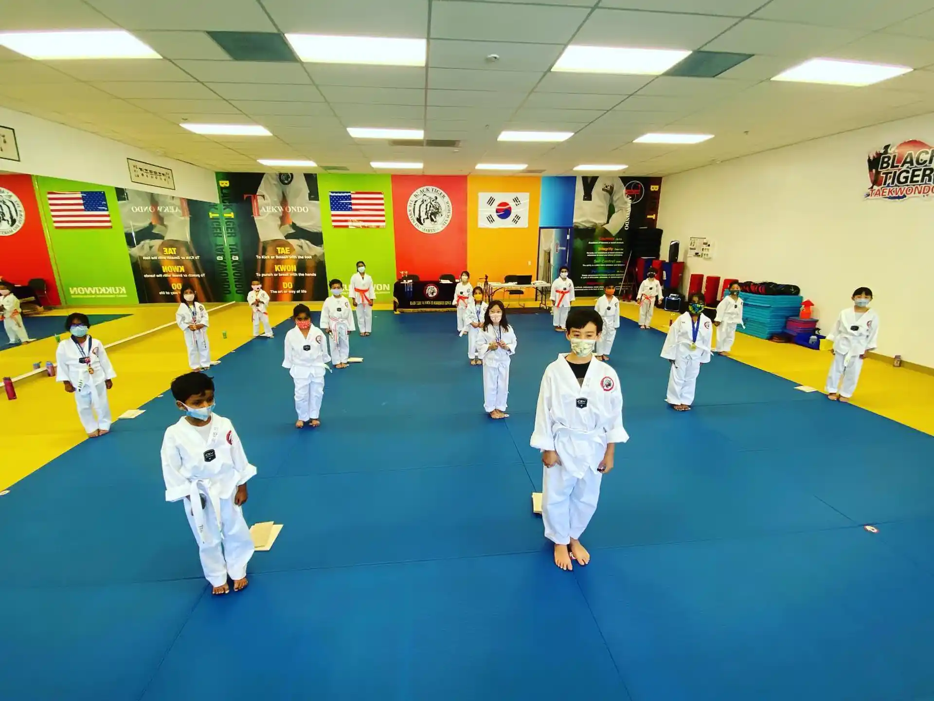 a group of children in karate uniforms