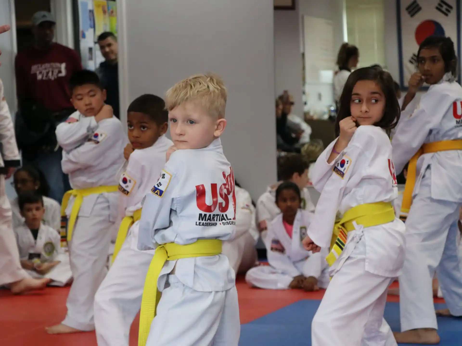 a group of children in karate uniforms