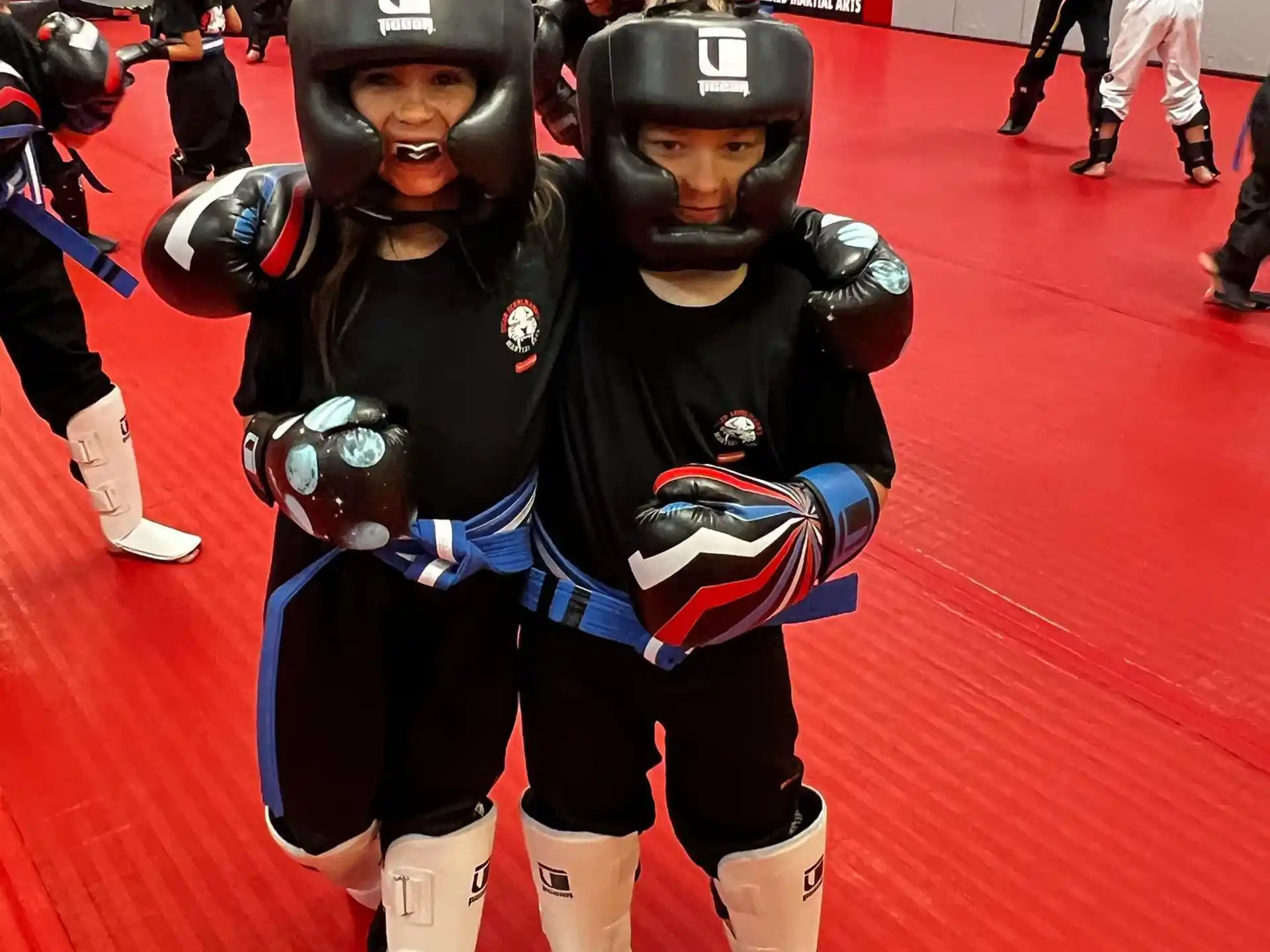 a couple people wearing helmets and holding balls