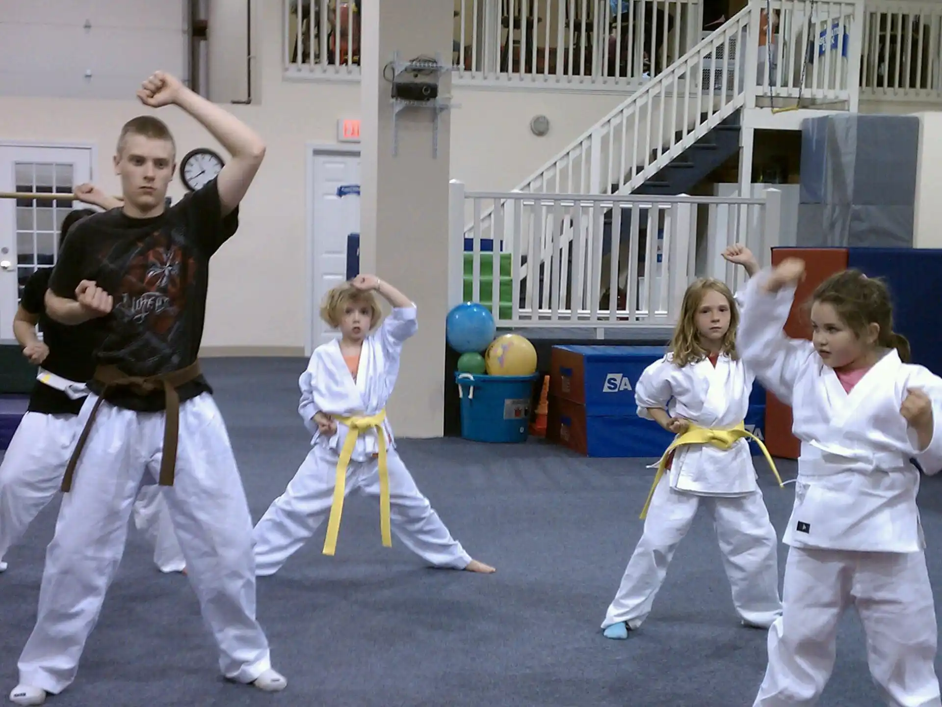 a group of children in karate uniforms