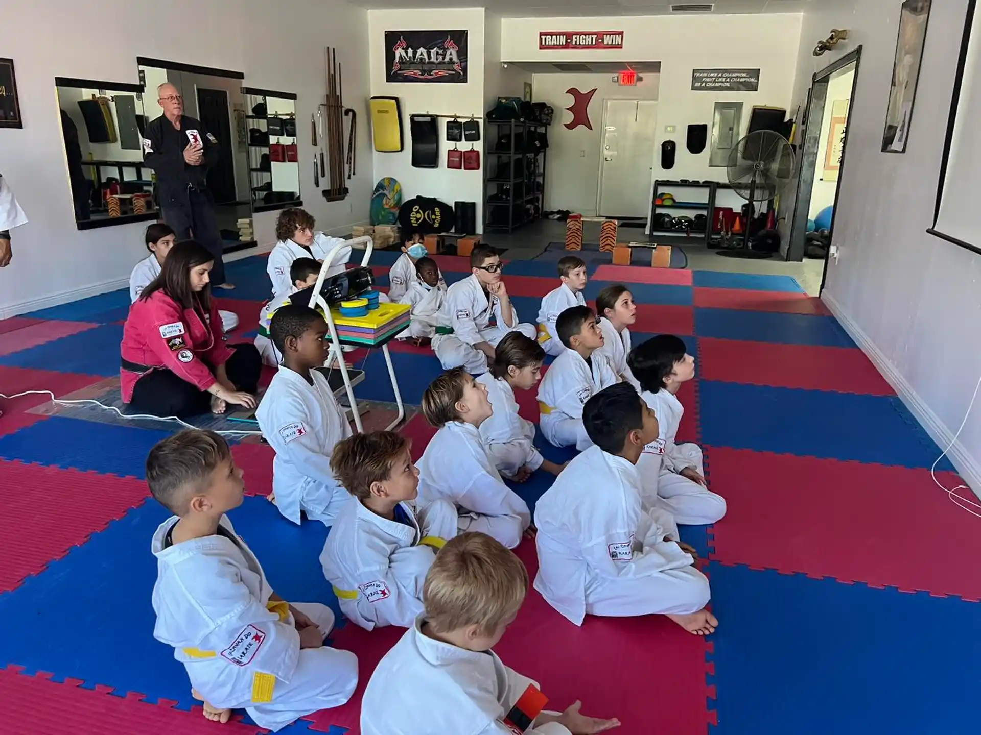 a group of children sitting on the floor in a room
