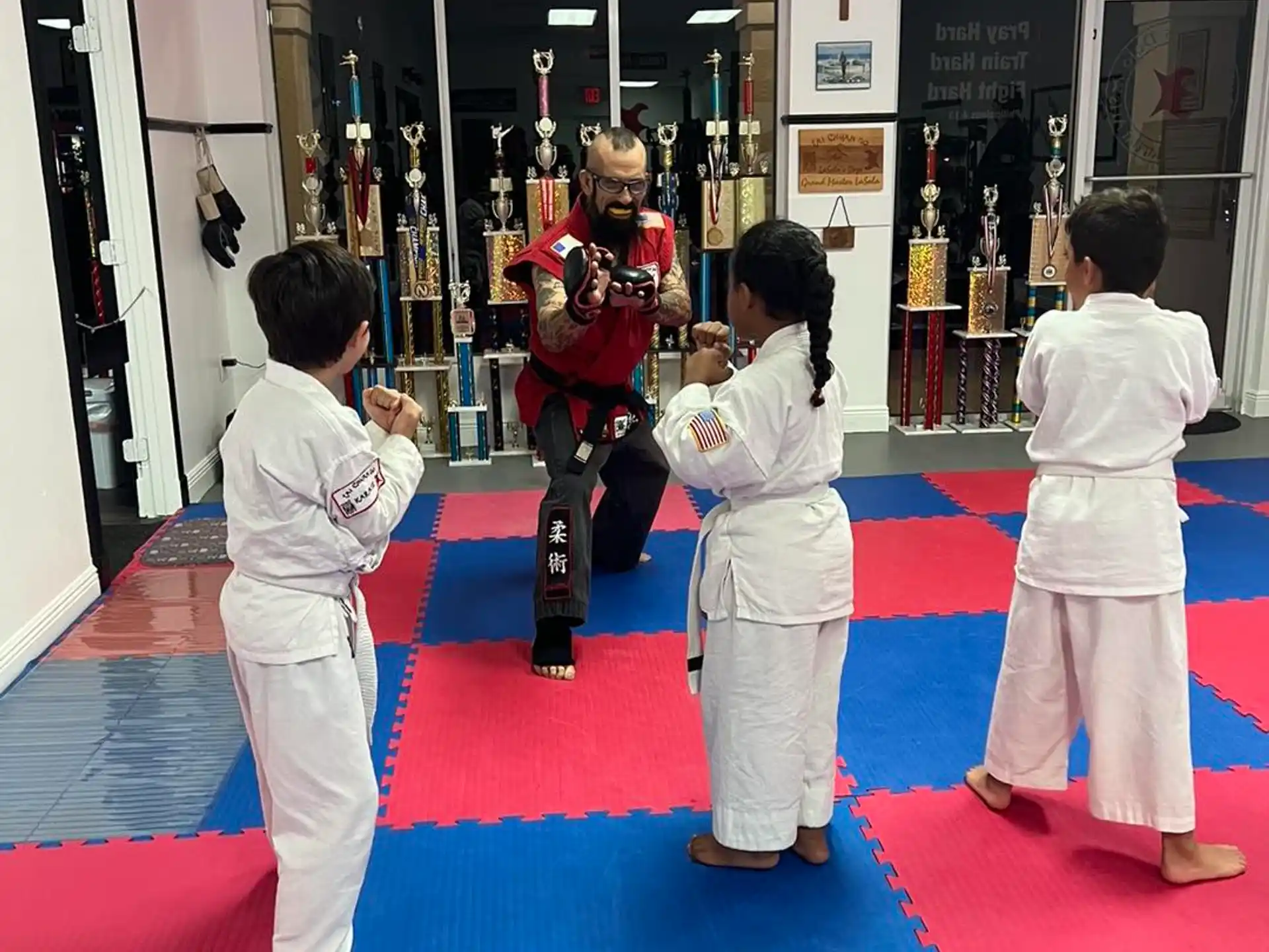 a group of kids in karate uniforms