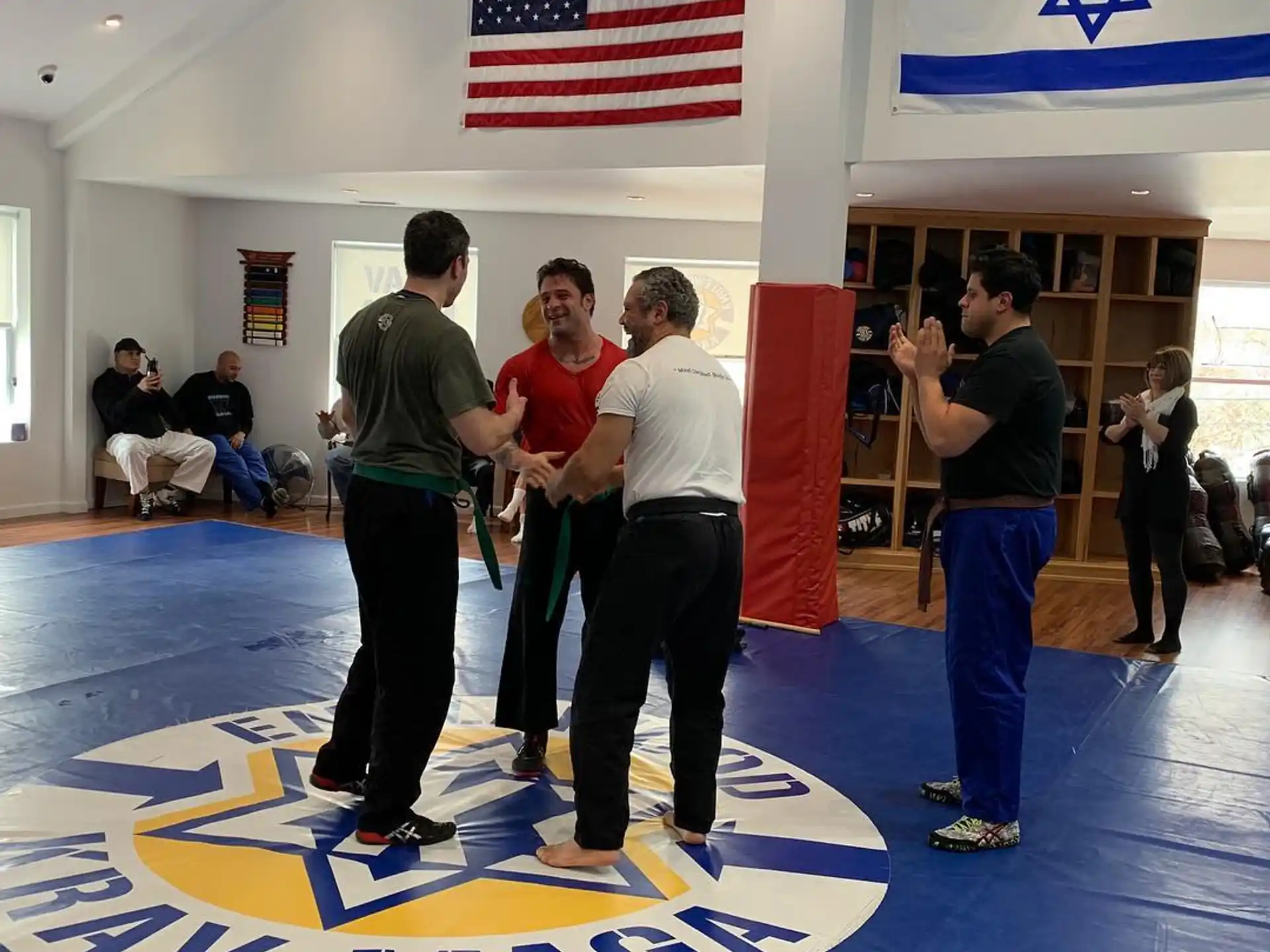 a group of people standing in a room with a flag