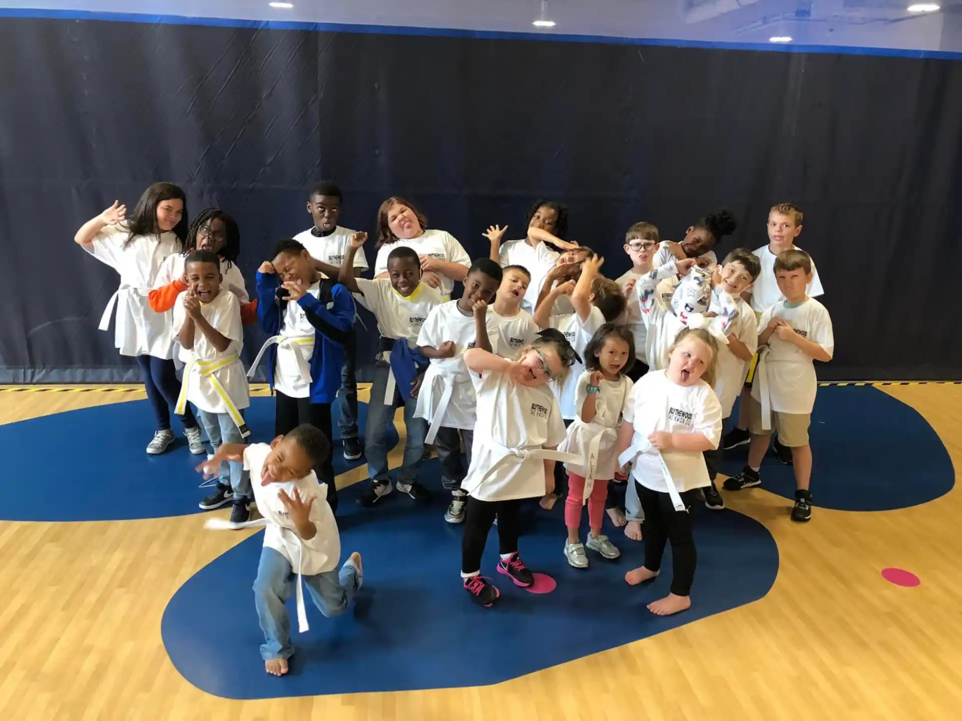 a group of children in white uniforms