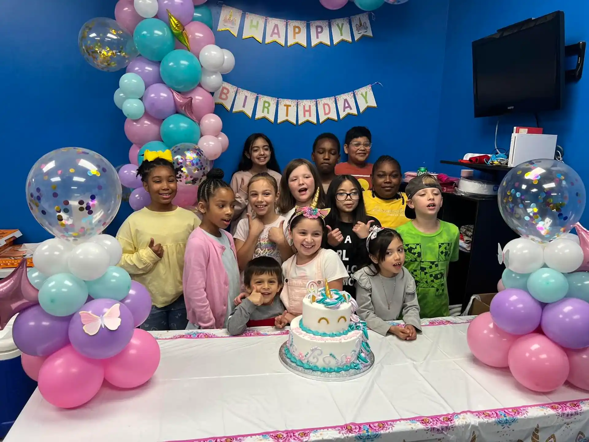 a group of people posing for a photo with a cake