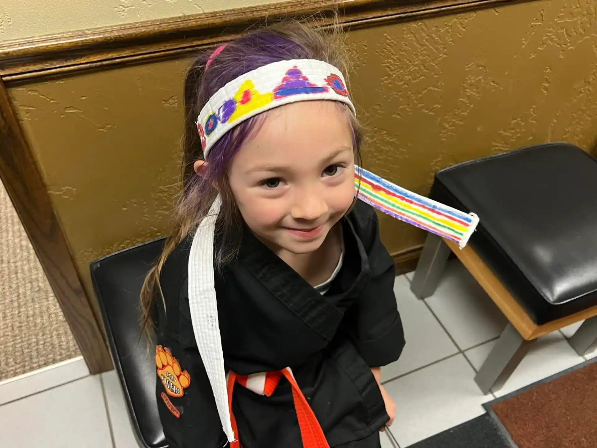 a girl wearing a colorful hat