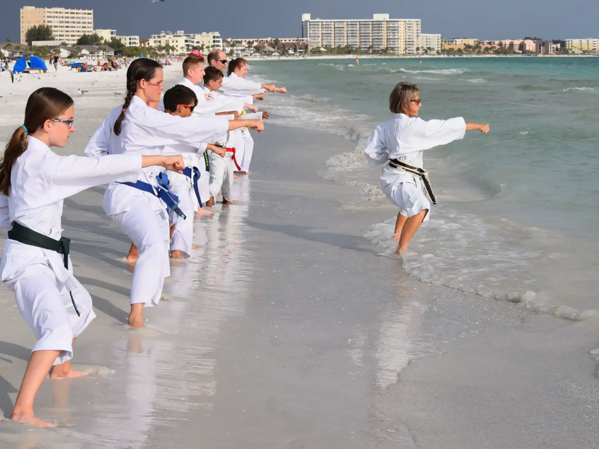 a group of people in white karate uniforms in the water