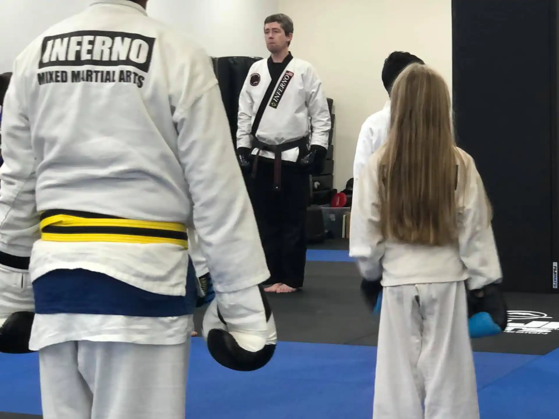a group of people in white karate uniforms