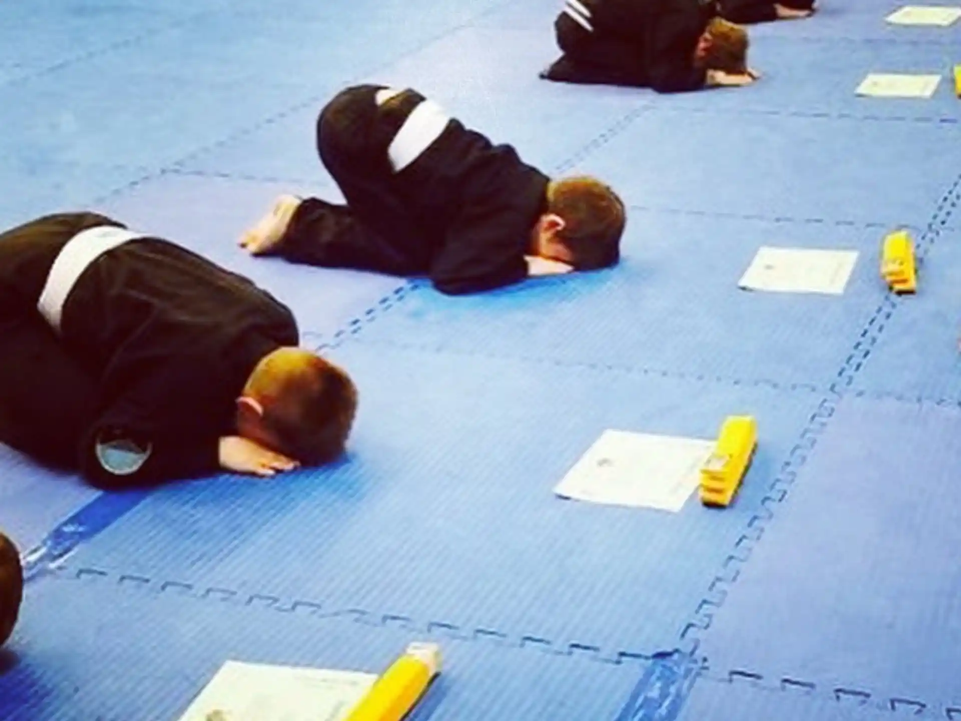 a group of people lying on the ground with their heads in their hands