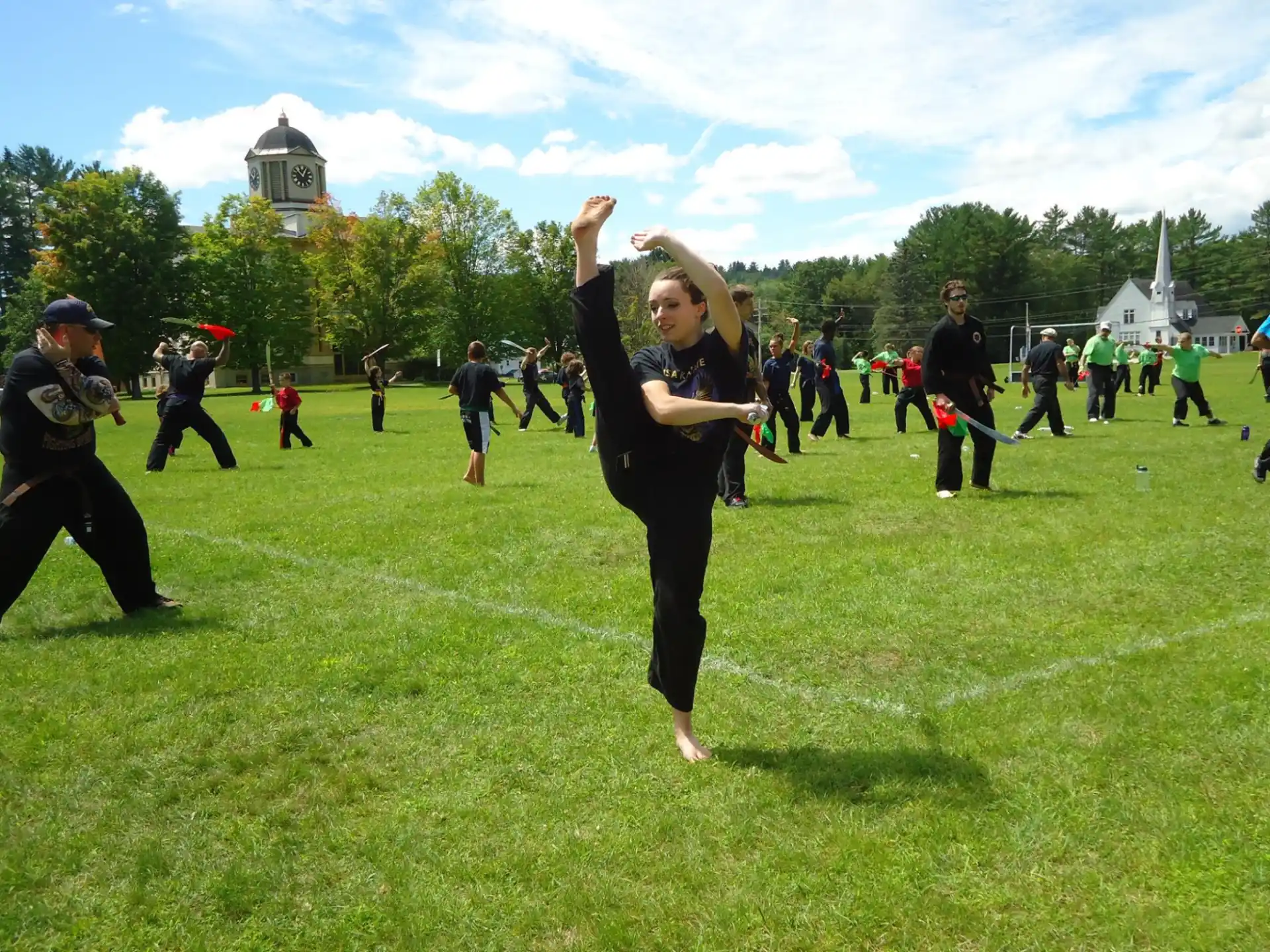 a group of people playing frisbee in a field