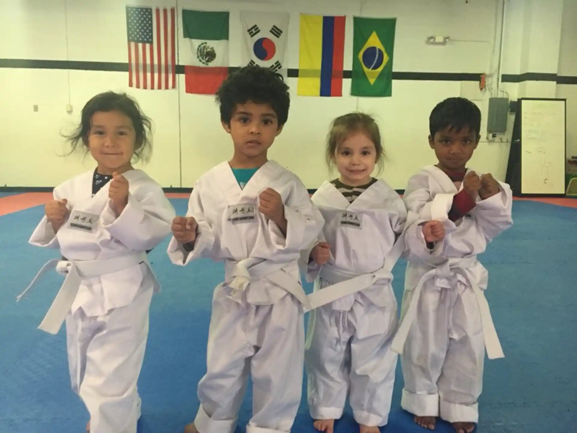 a group of kids in karate uniforms