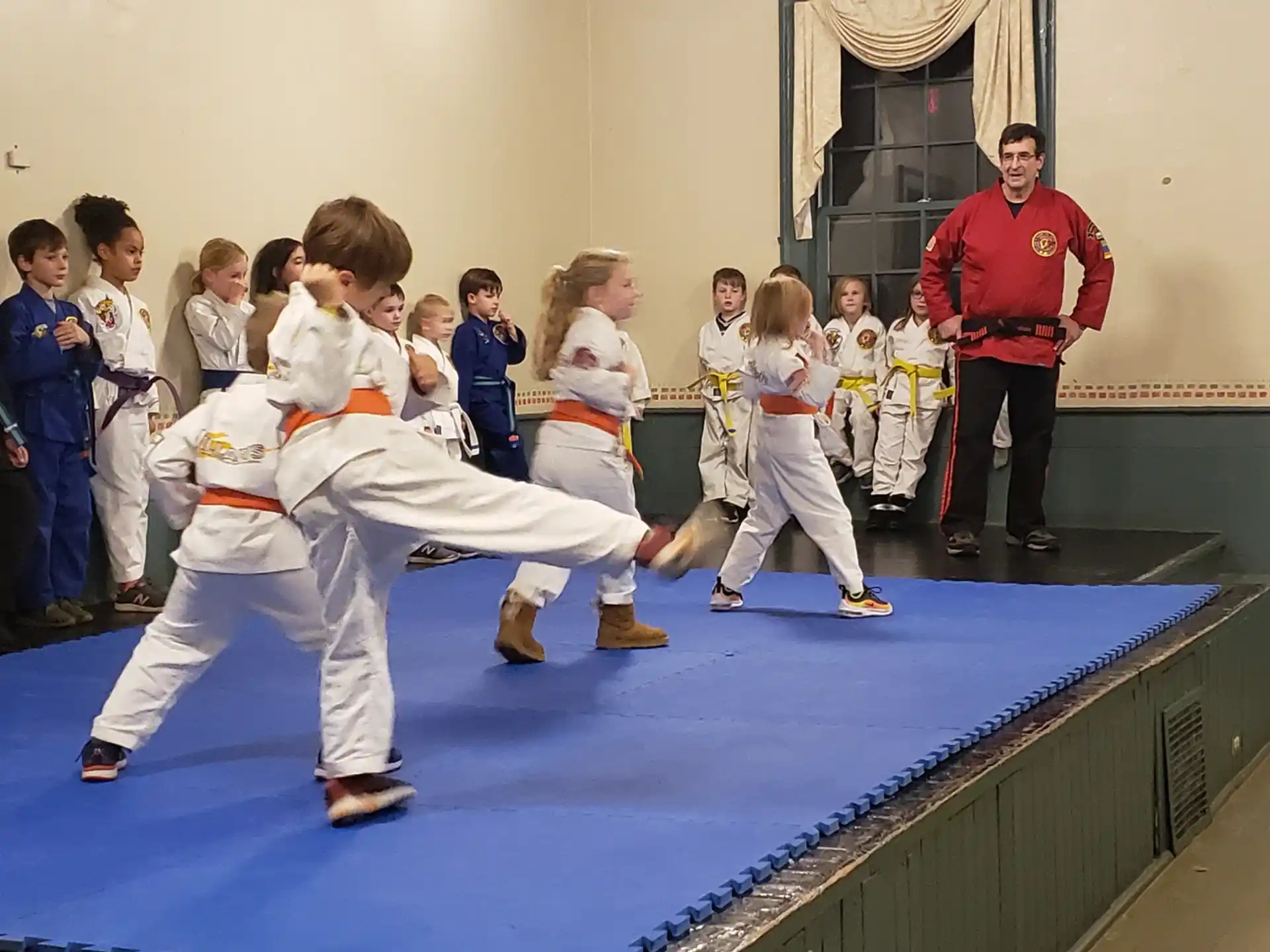 a group of children in karate uniforms