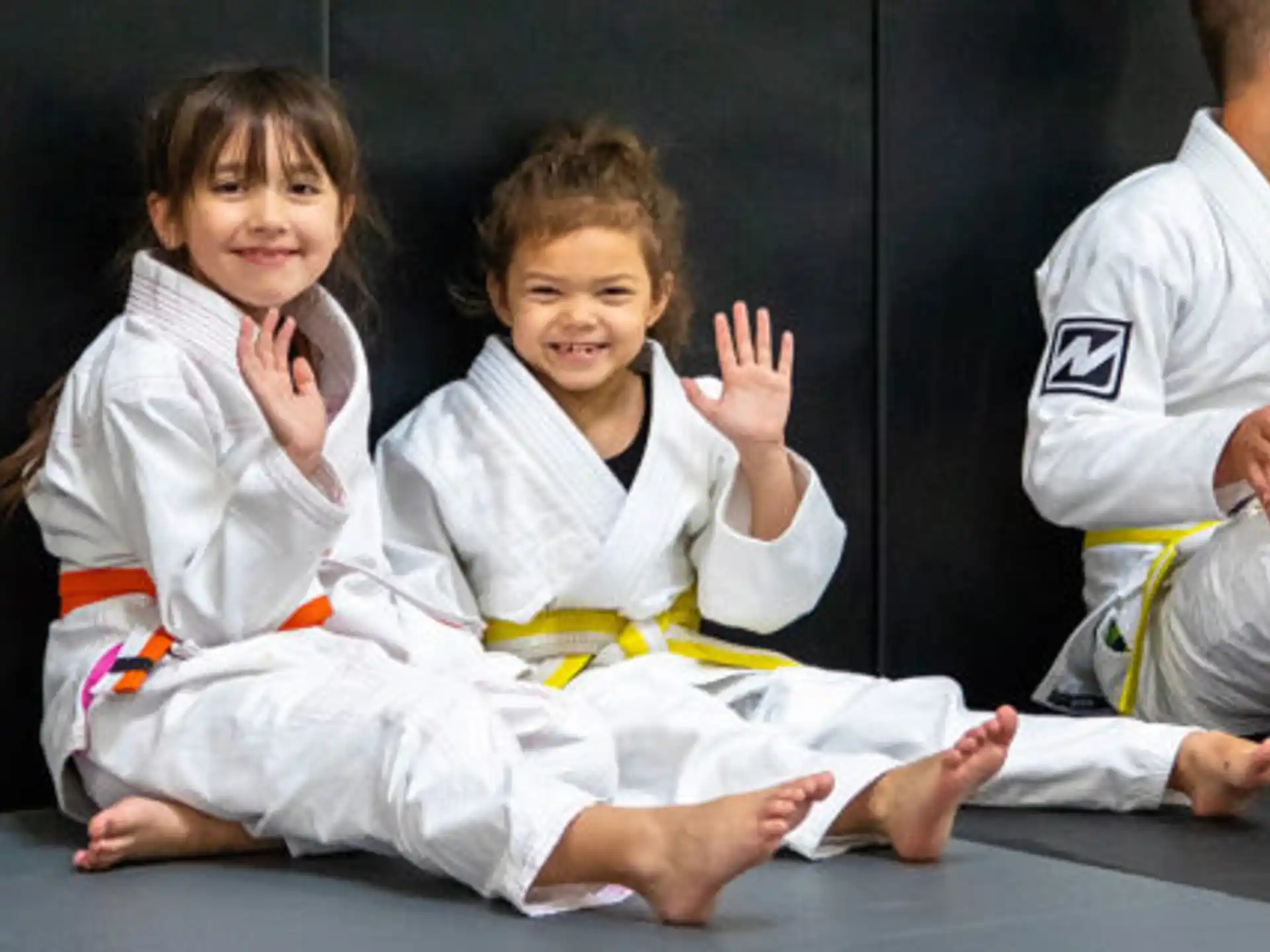 a few young girls in karate uniforms