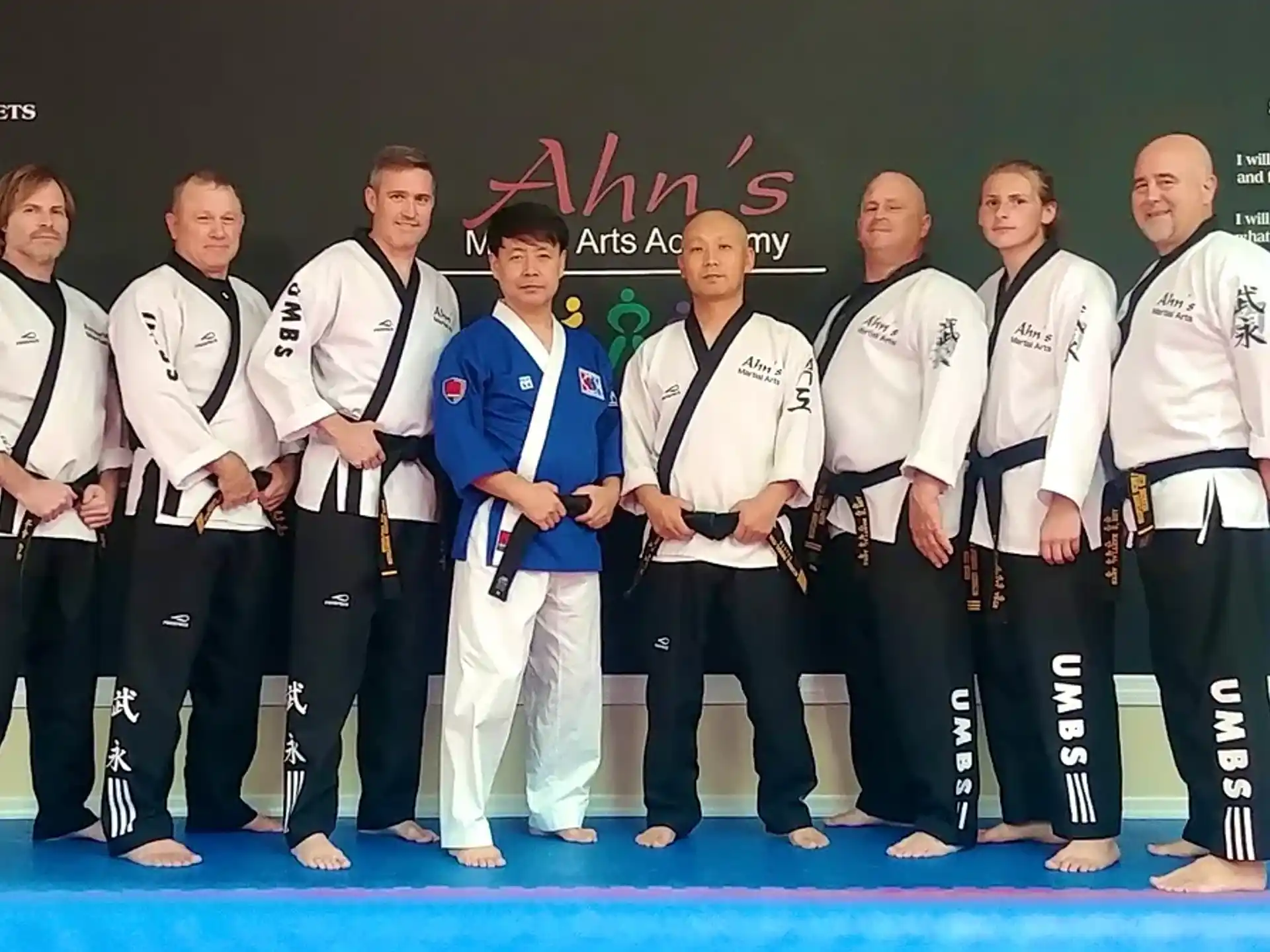 a group of people in karate uniforms