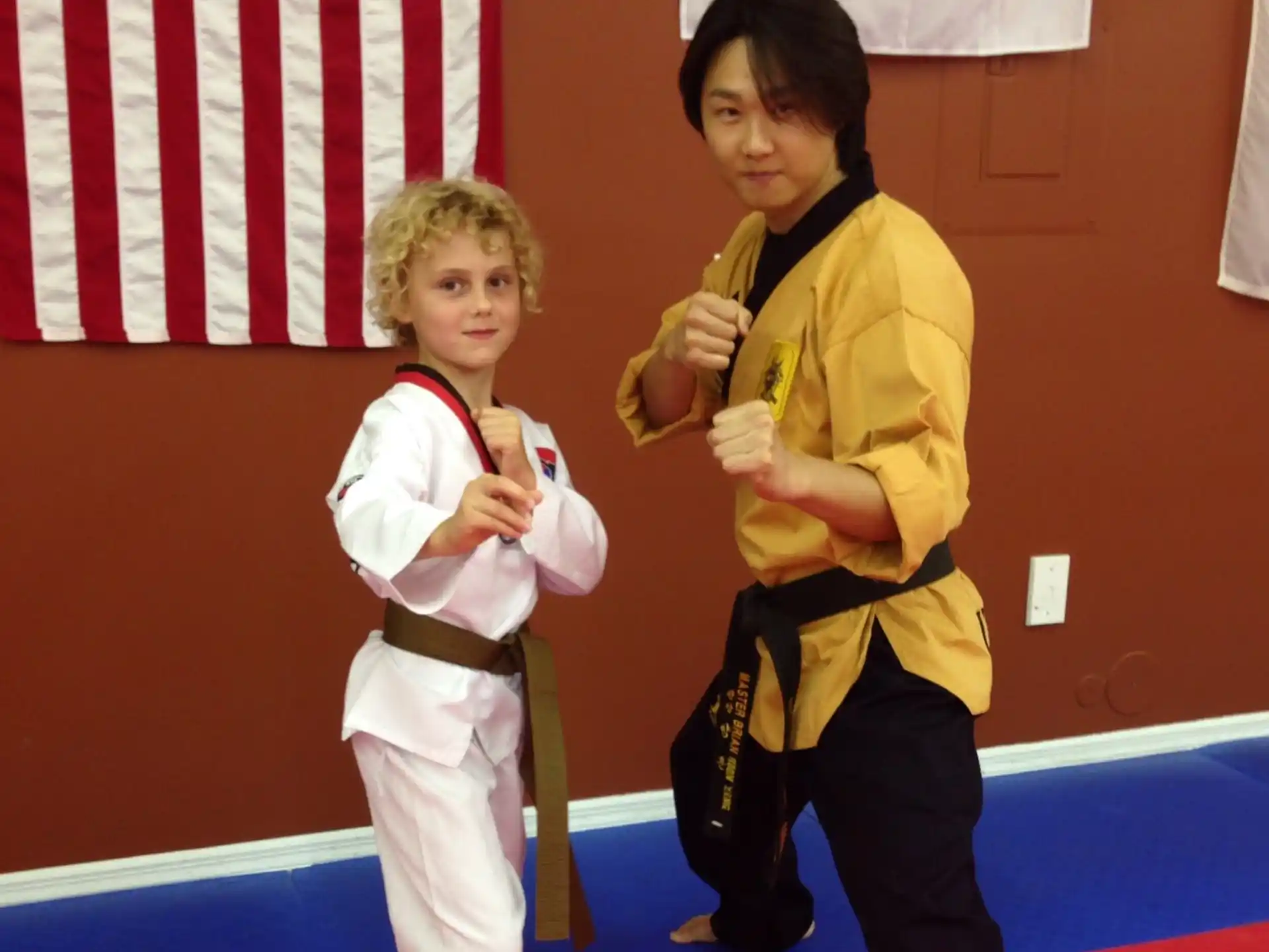 a person and a child in karate uniforms