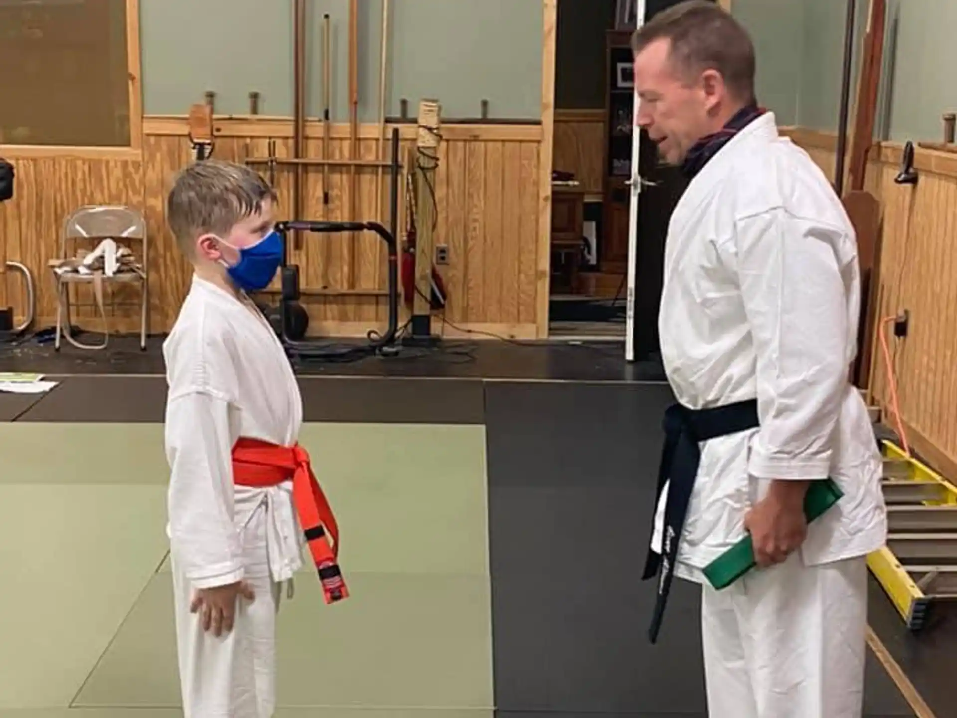 a man and a boy in karate uniforms