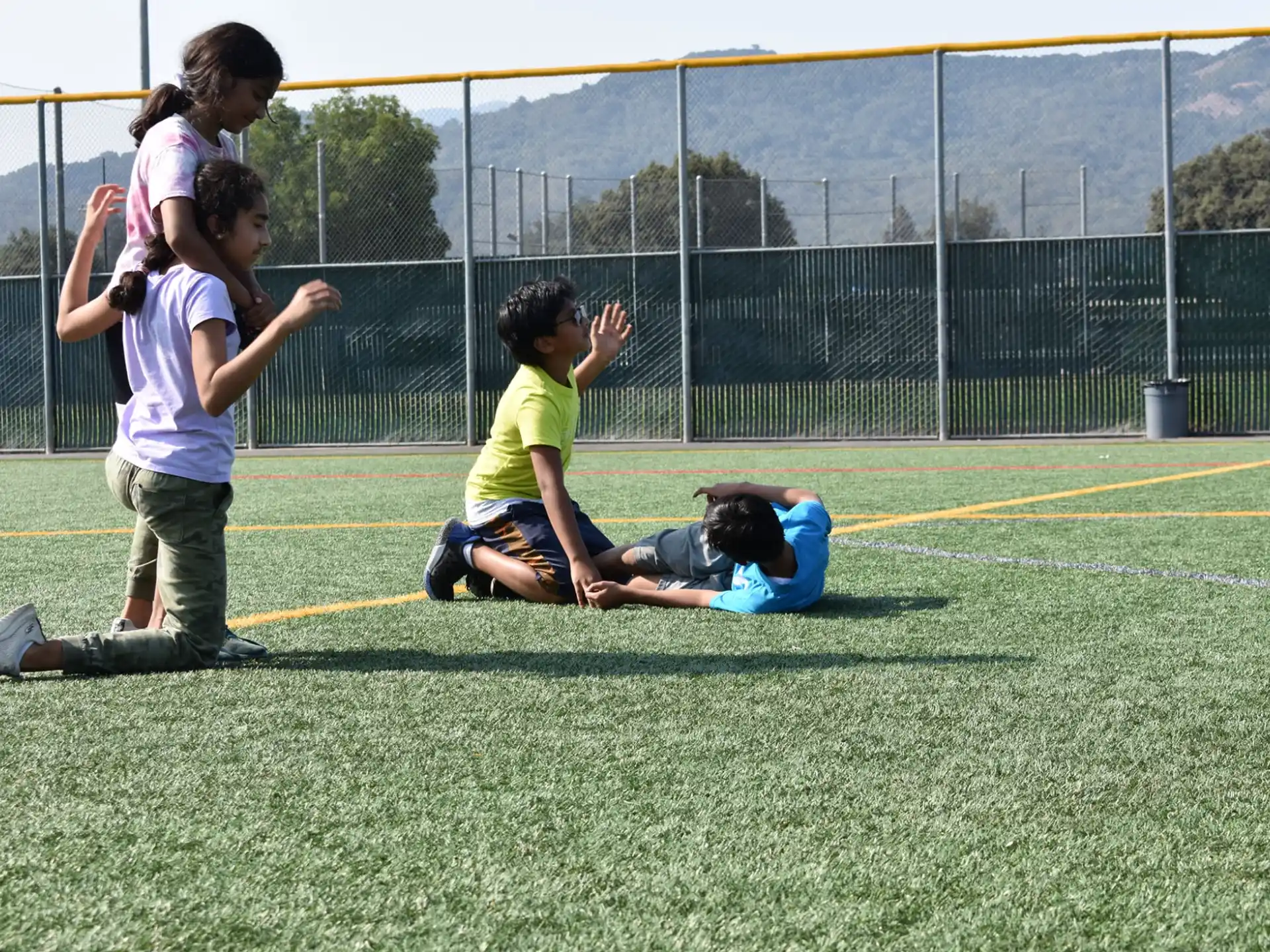 a group of kids playing on a field