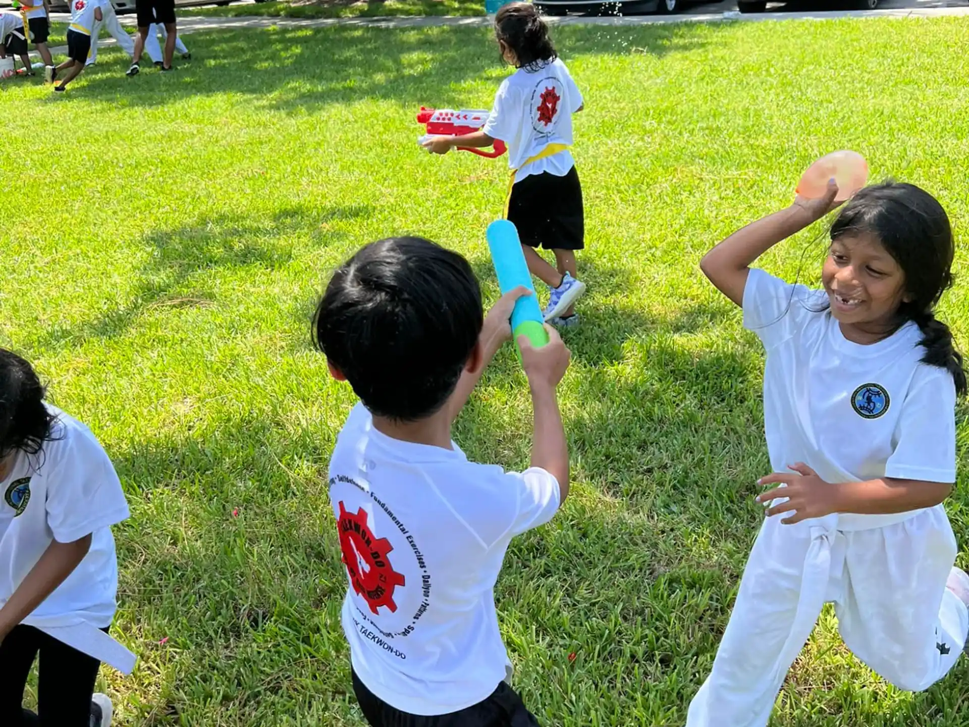 a group of kids playing with frisbees